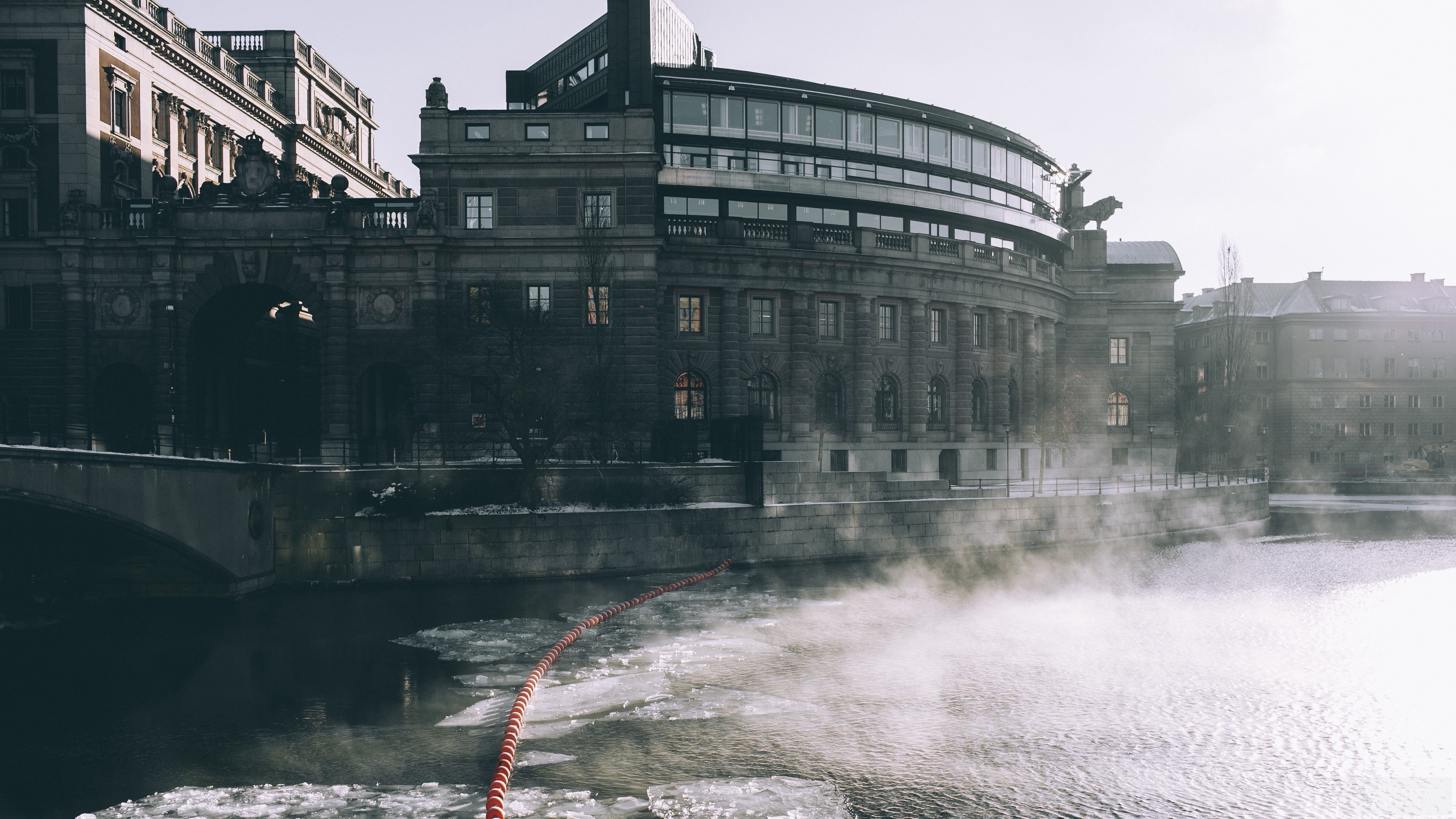 Building by the river with ice and steam HD Wallpaper