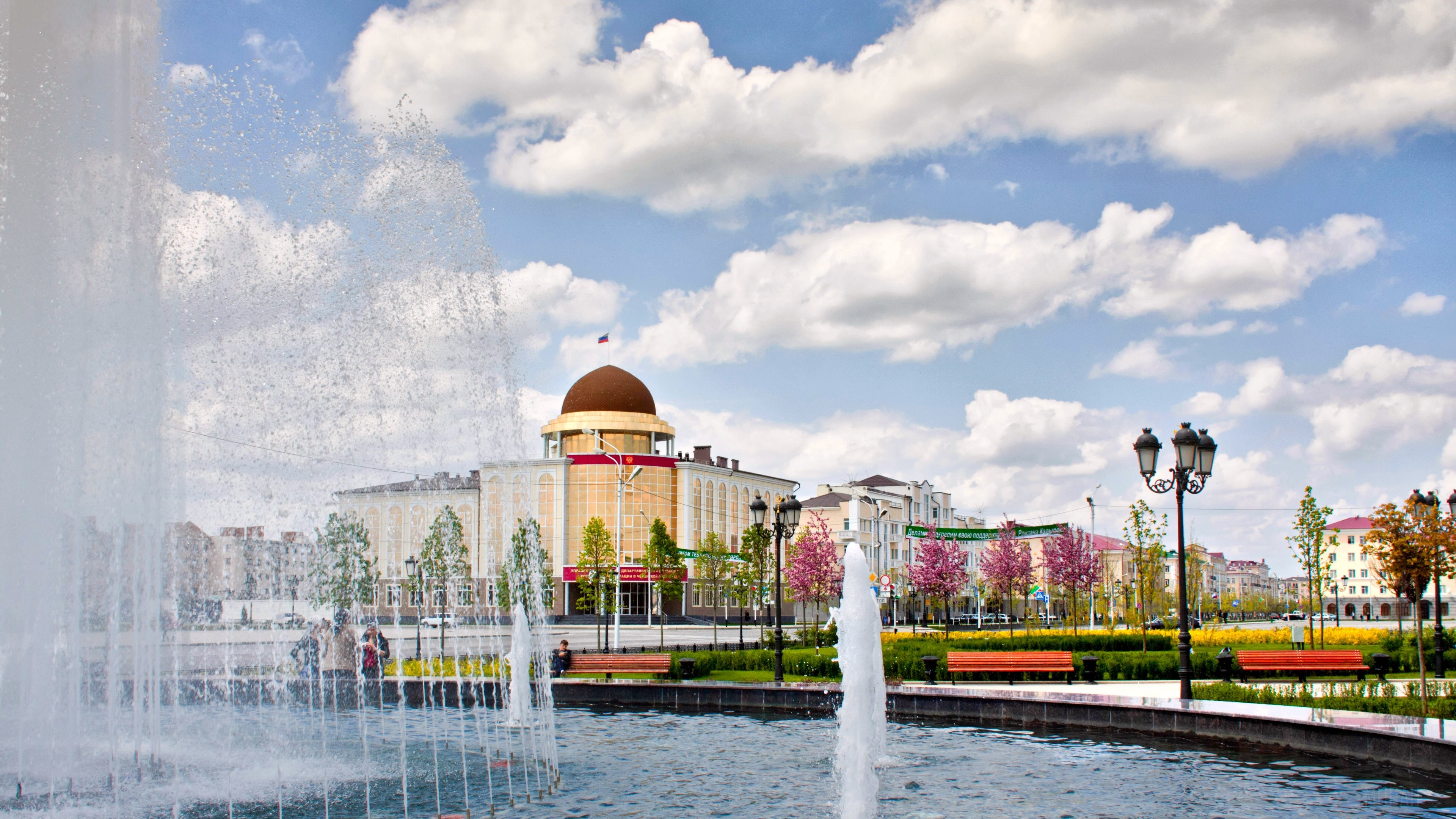 Fountain in Grozny, Chechnya with buildings and flowers HD Wallpaper