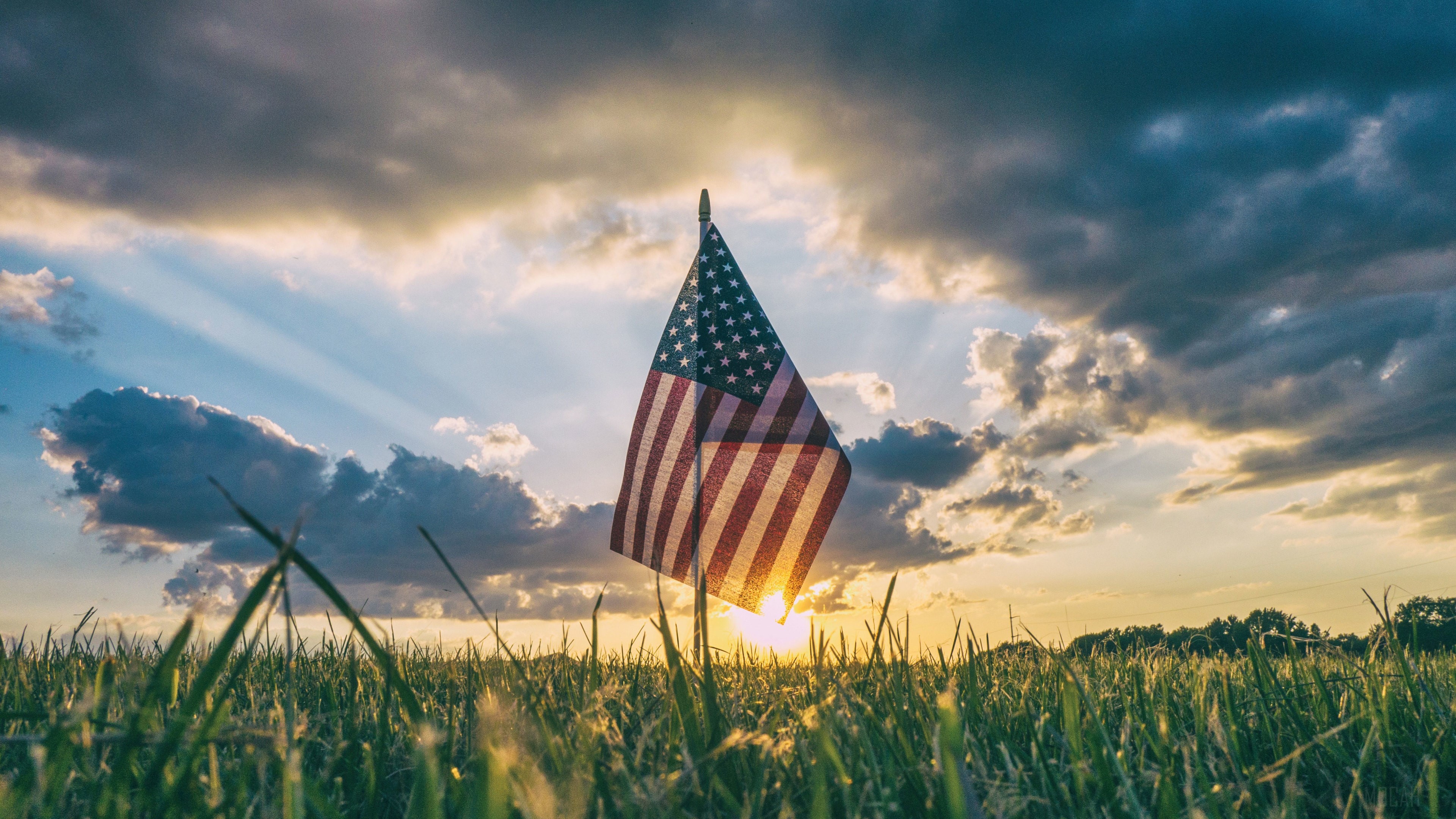American Flag in a Field at Sunset HD Wallpaper