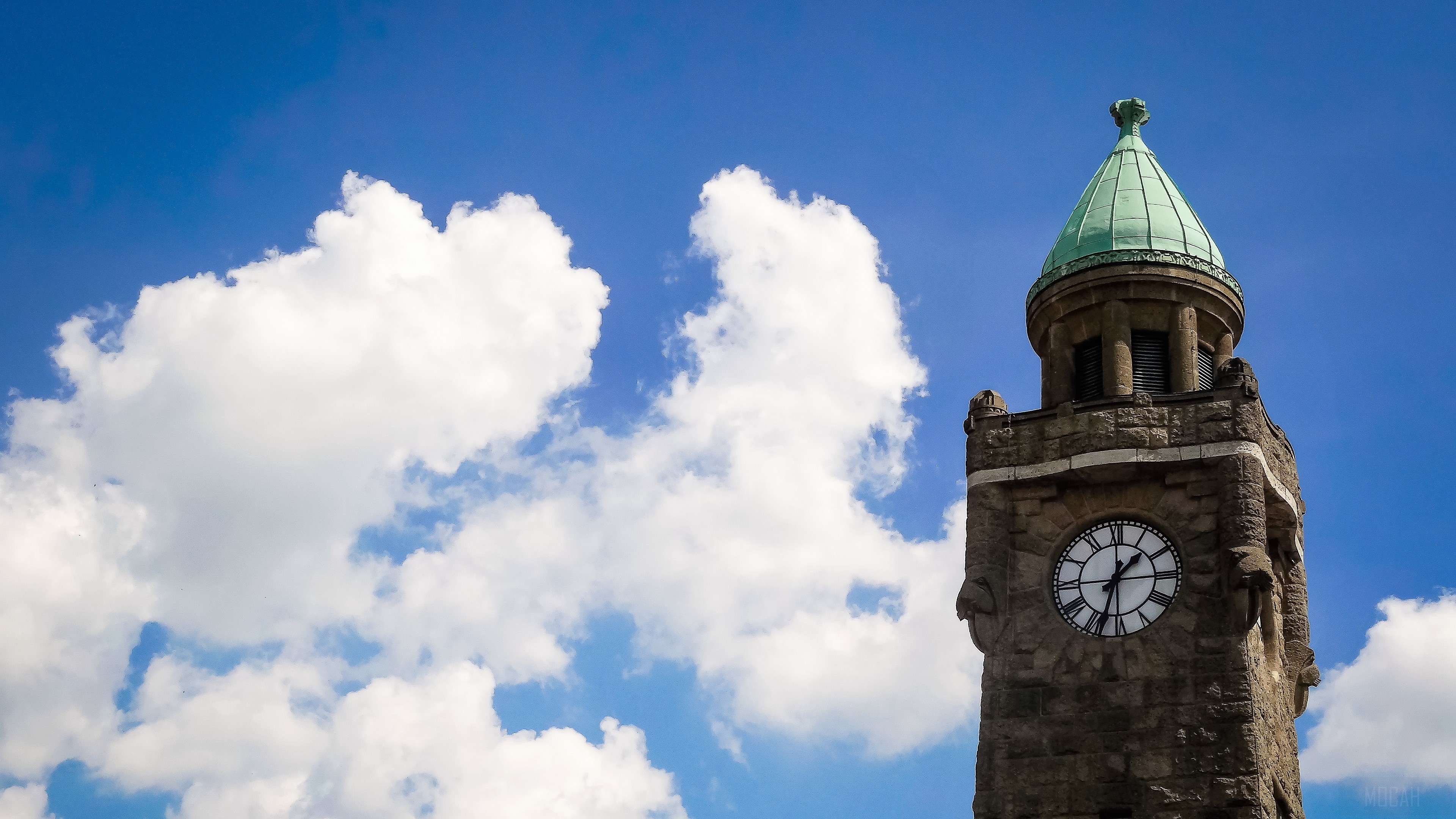 Stone tower with clock and green dome against blue sky with clouds HD Wallpaper