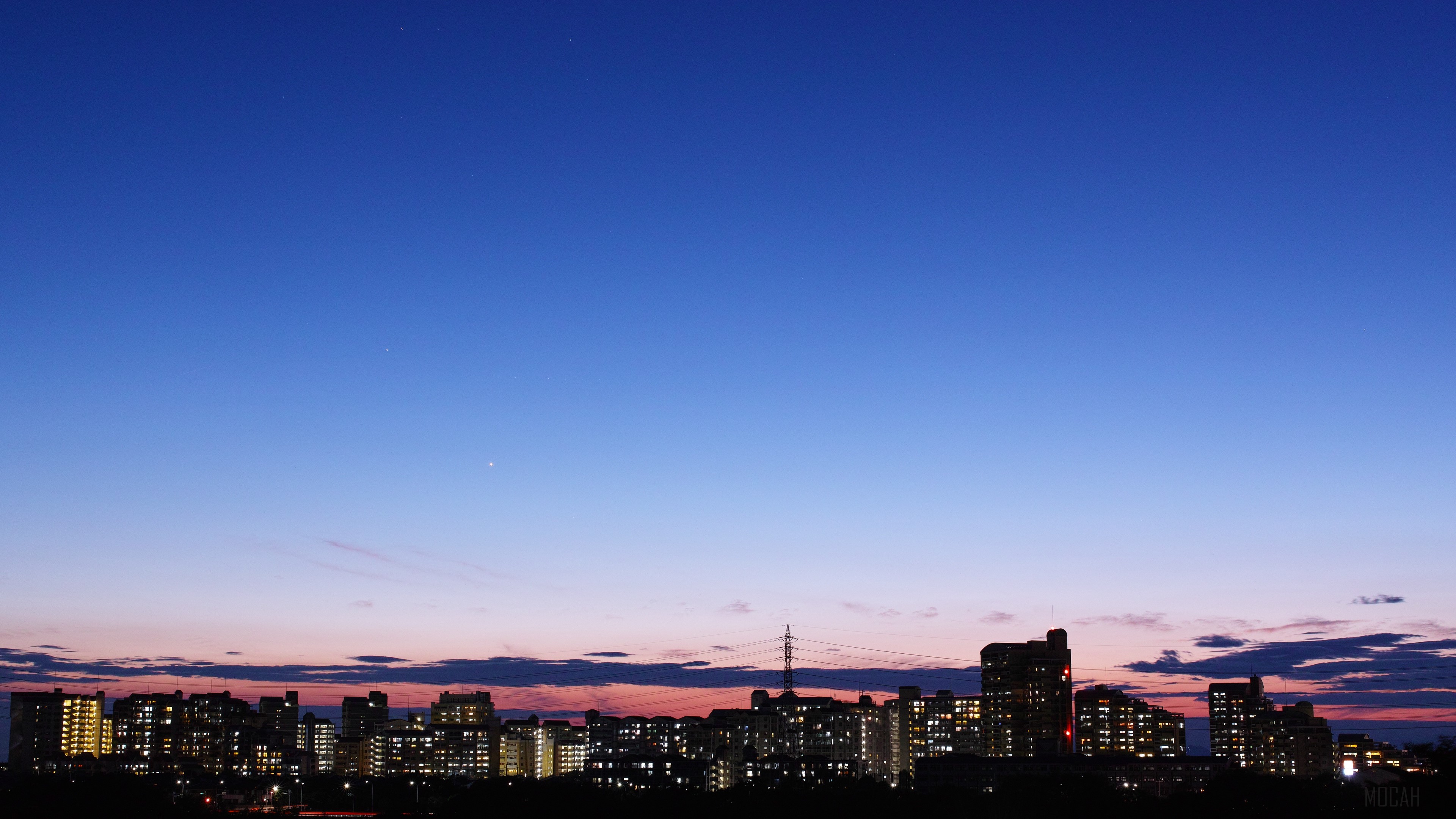 City skyline at dusk with a clear blue sky HD Wallpaper