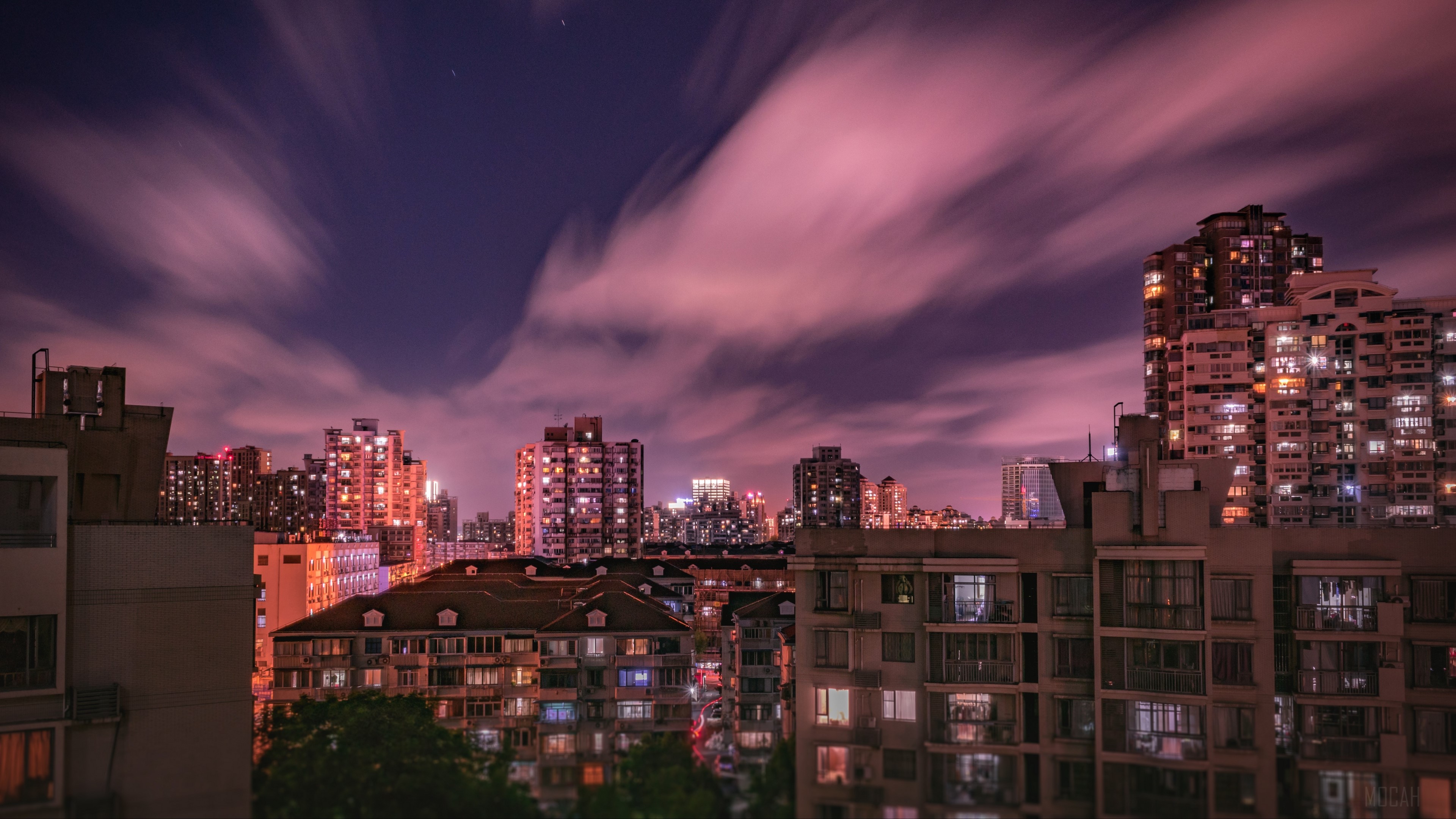 Cityscape at night with pink clouds HD Wallpaper