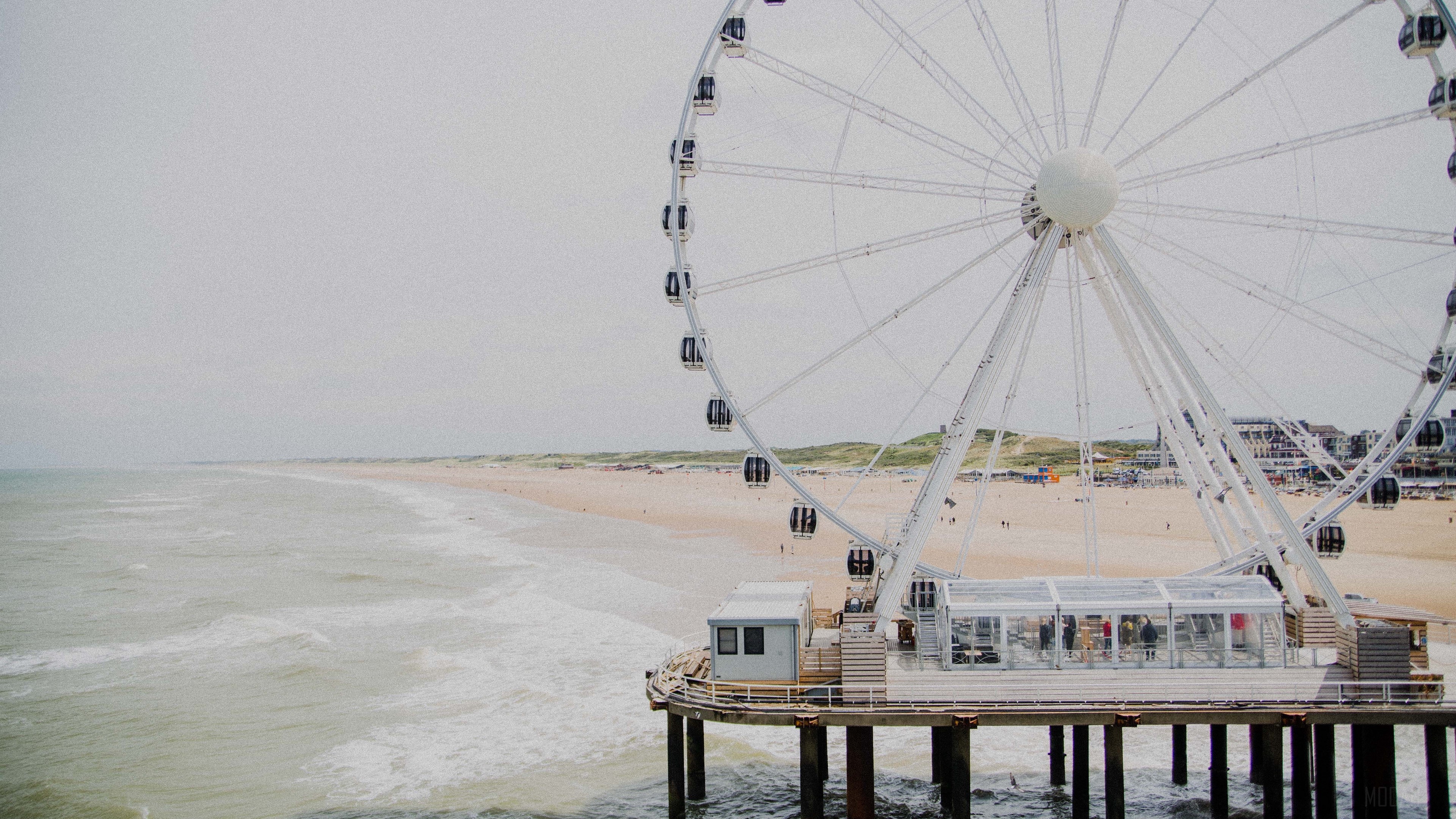 Ferris wheel attraction on a beach 4K HD Wallpaper