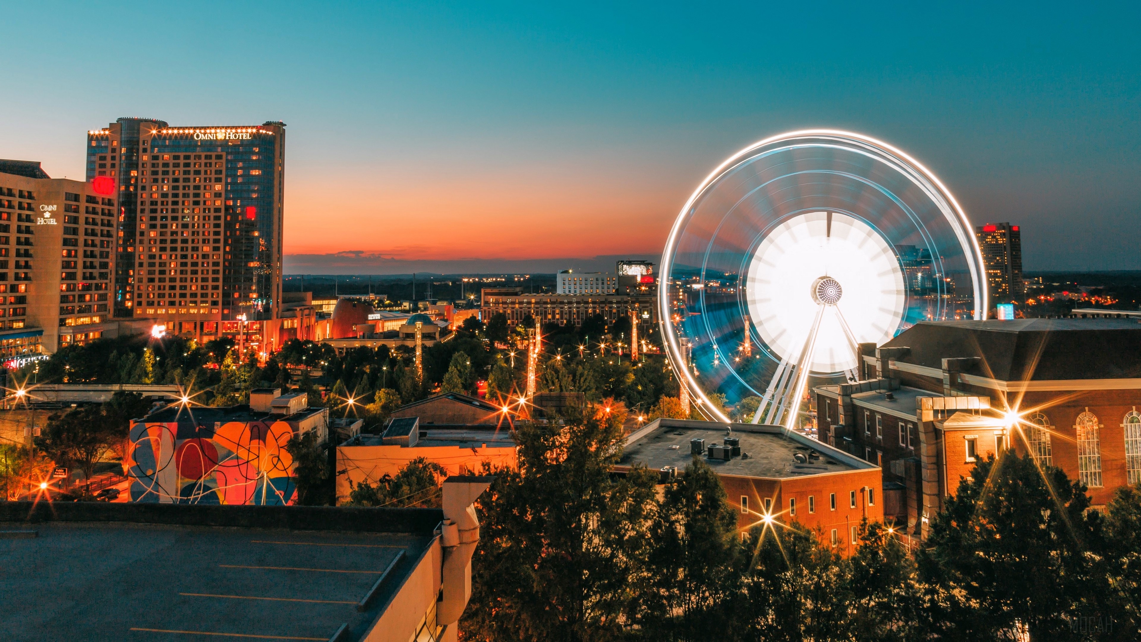 City skyline with Ferris wheel at dusk 4K HD Wallpaper
