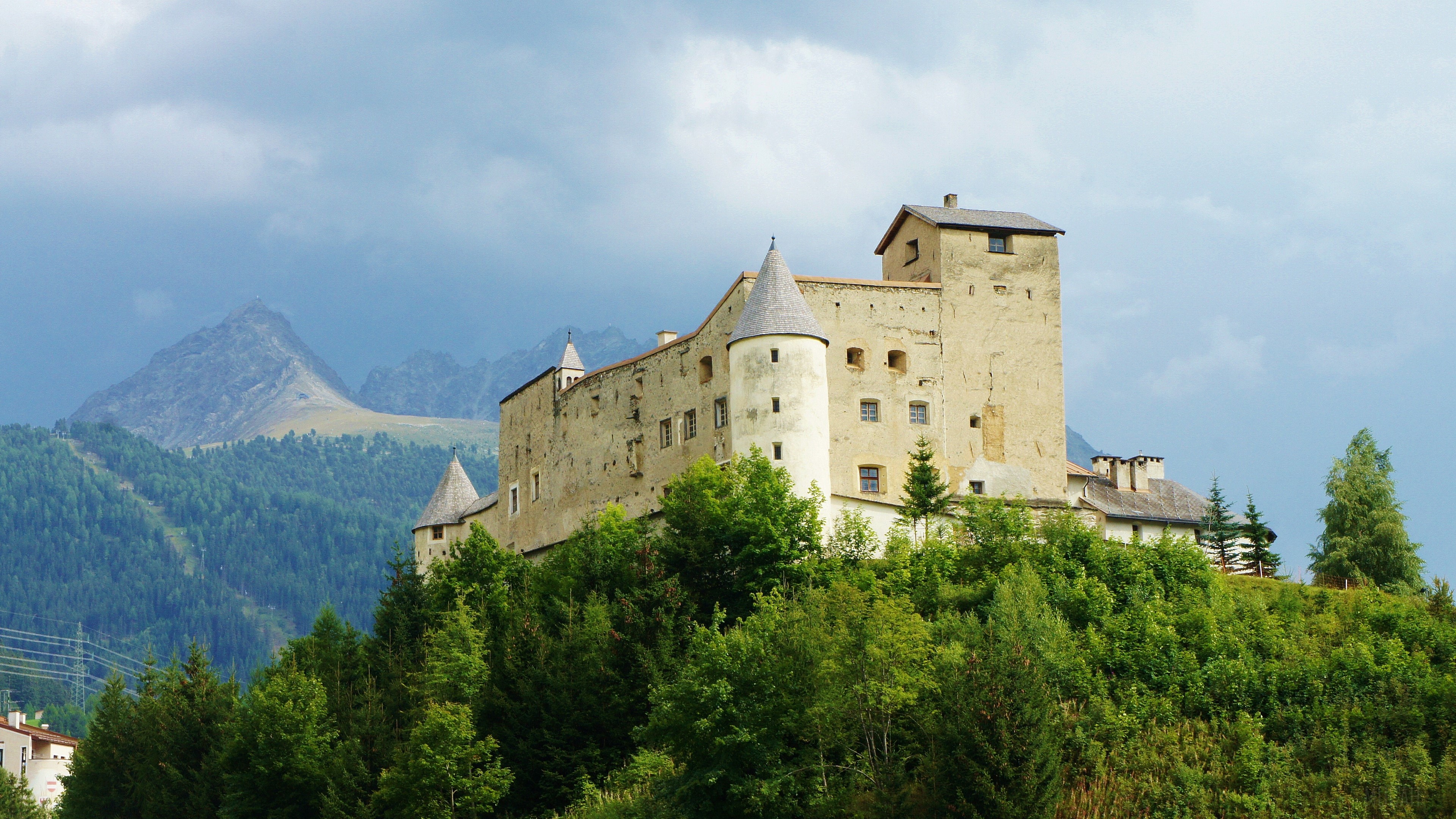 Castle on a hill with mountains and trees 4K HD Wallpaper