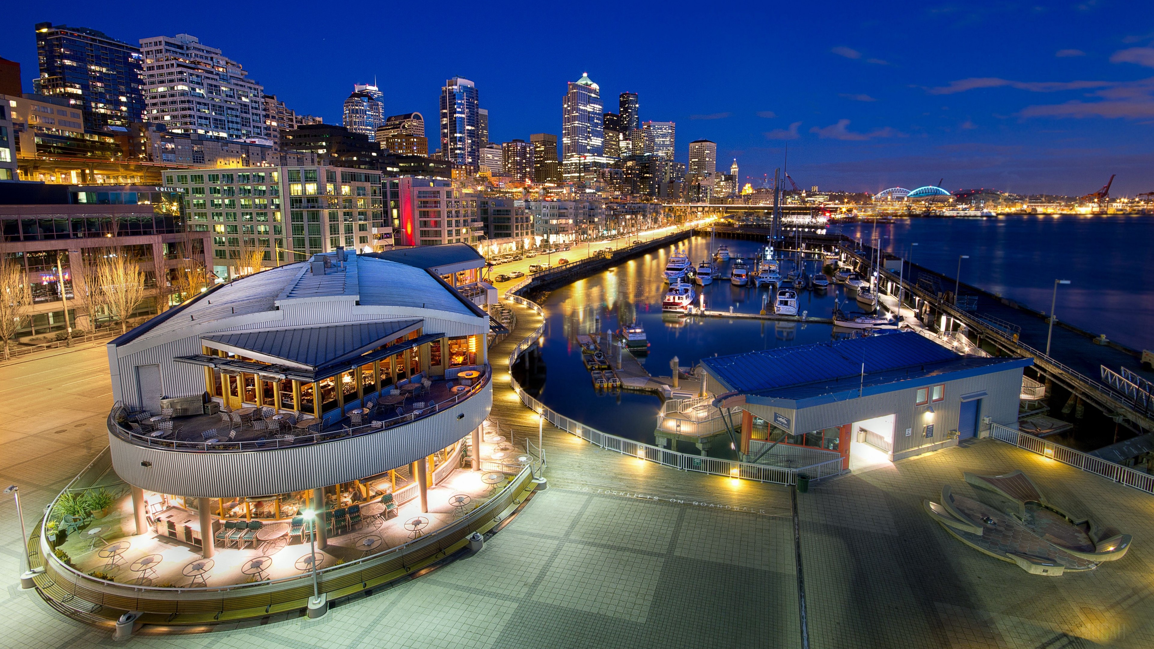 Seattle waterfront at night with city skyline and marina HD Wallpaper