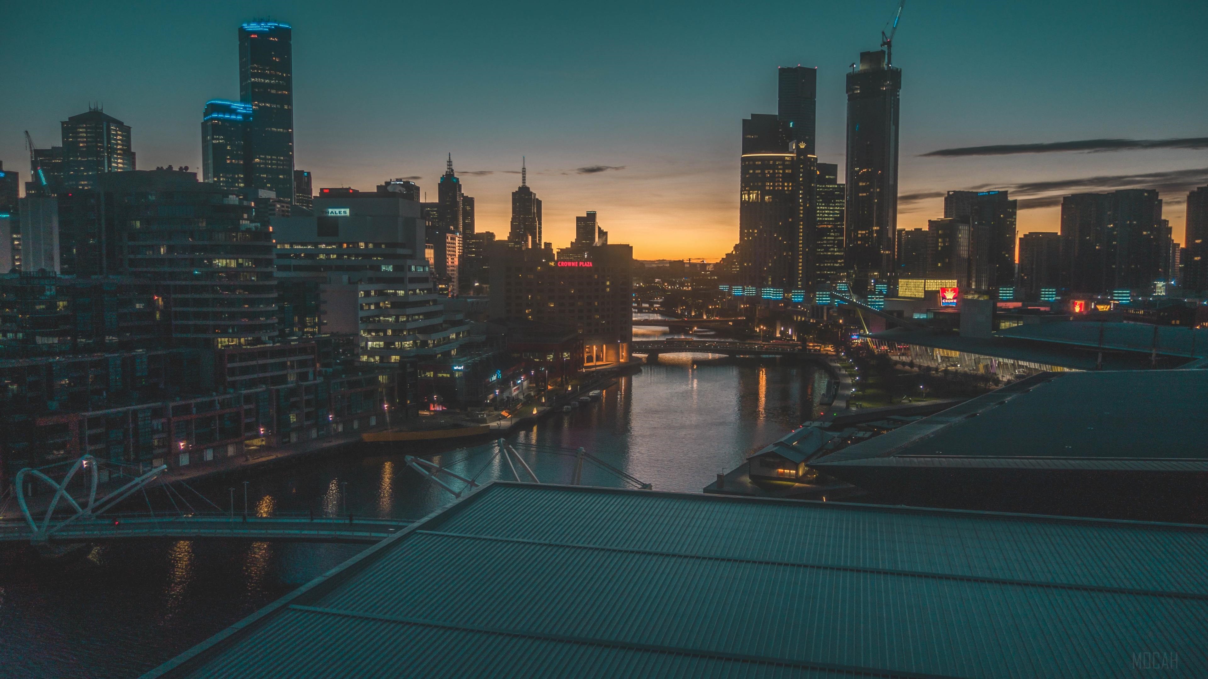 Cityscape with River and Buildings at Dusk 4K HD Wallpaper