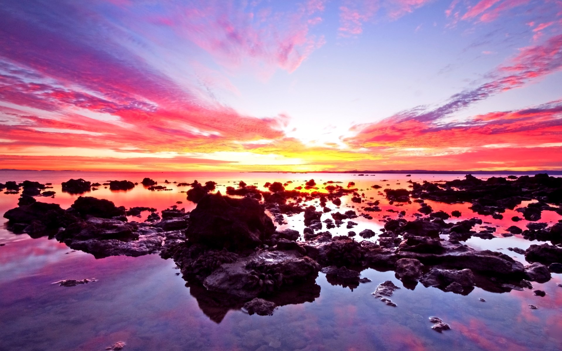 Colorful sunset over rocky shore and ocean HD Wallpaper