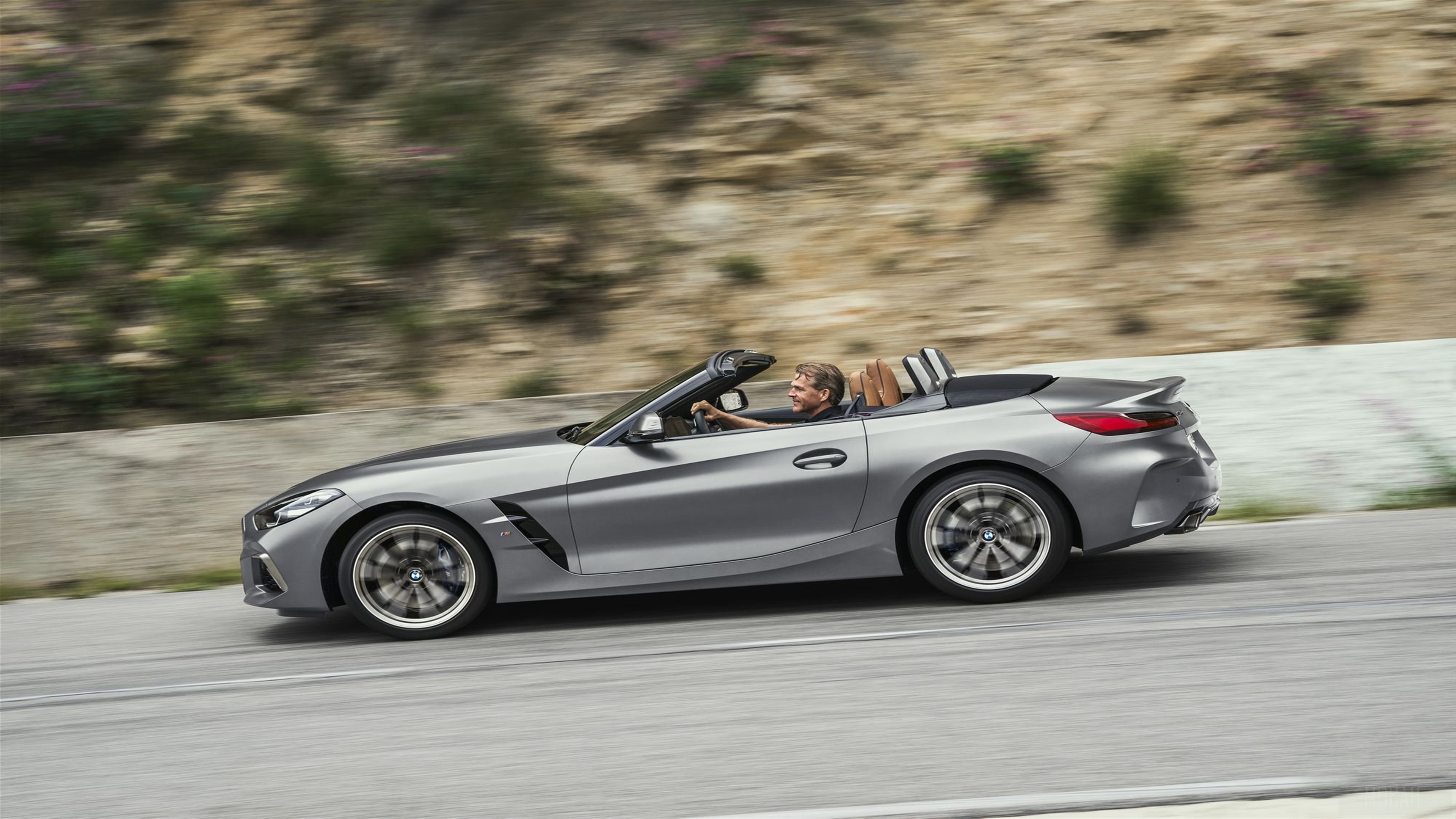 2019 BMW Z4 sDrive20i convertible driving on a road HD Wallpaper