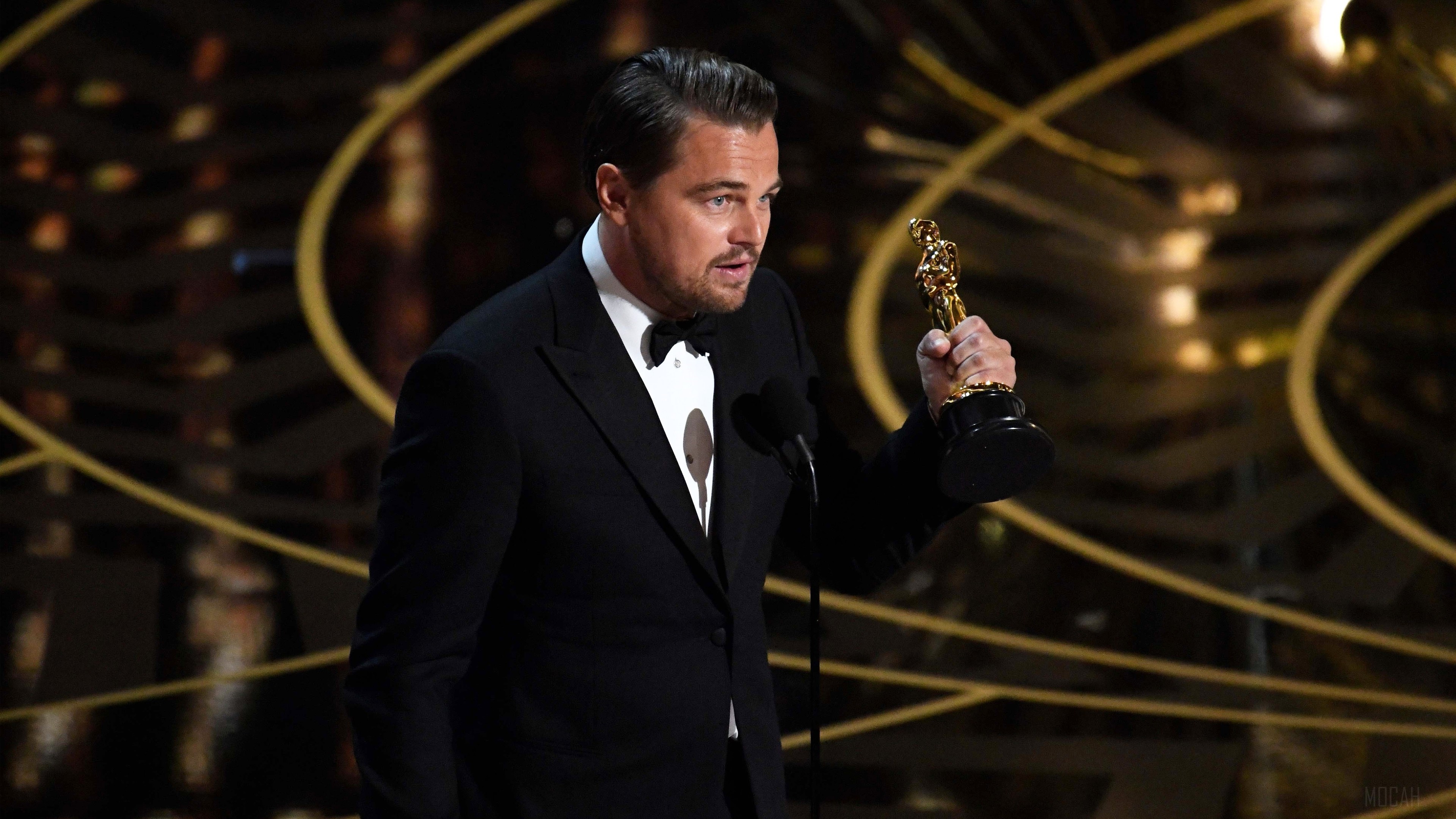 Leonardo DiCaprio holding an Oscar award HD Wallpaper