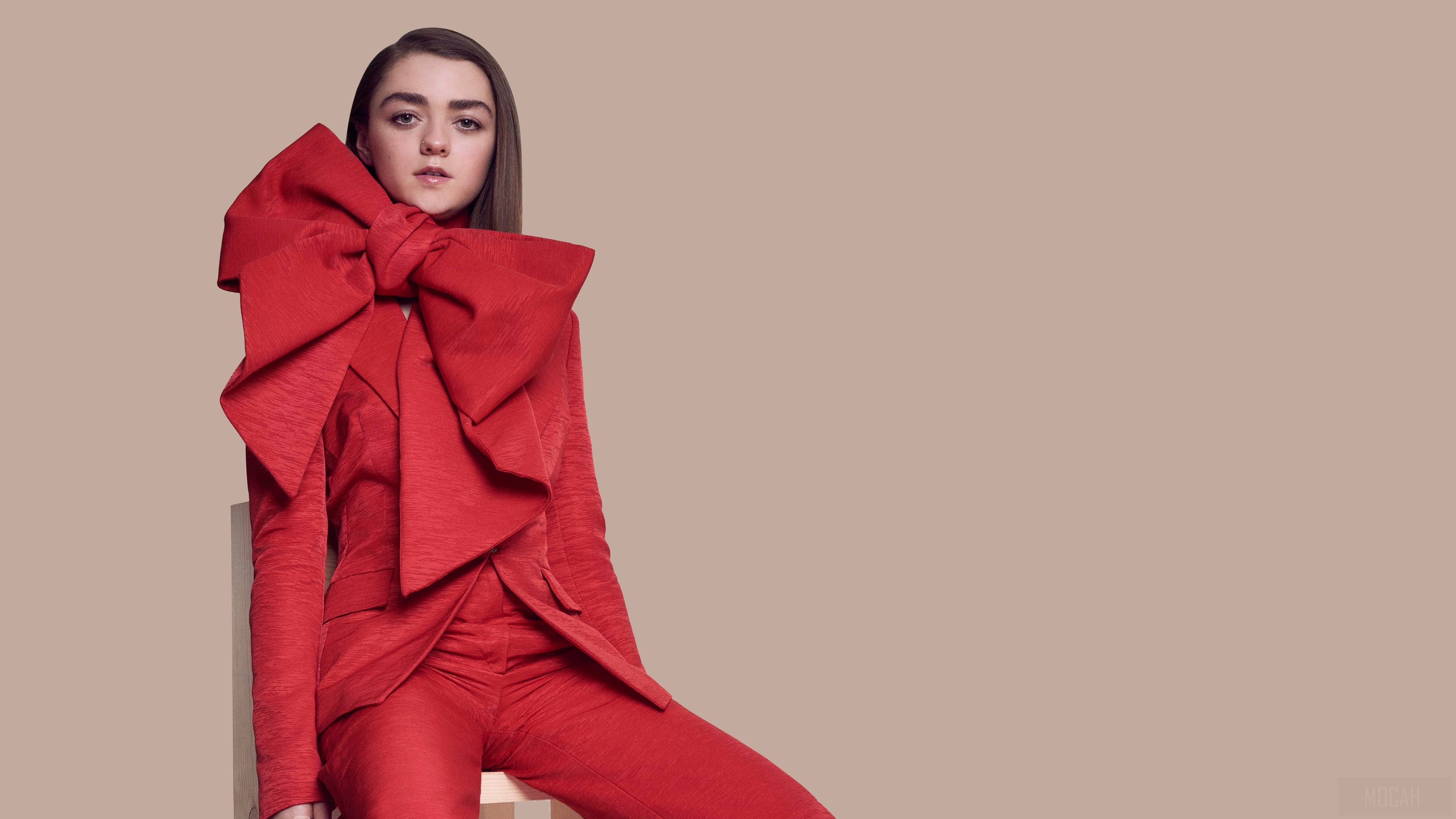 Maisie Williams in red suit with large bow HD Wallpaper