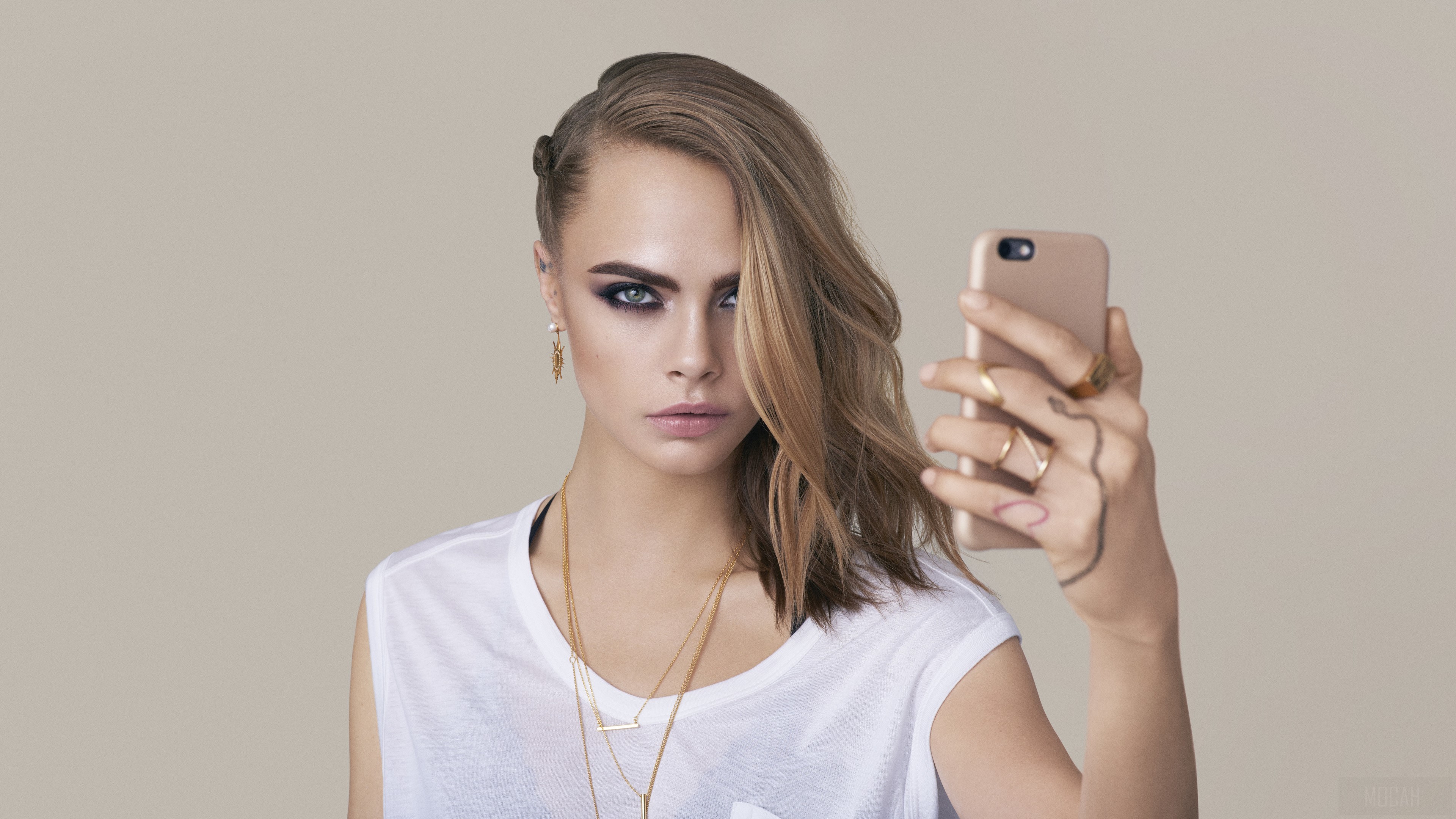 Cara Delevingne taking a selfie with a phone HD Wallpaper