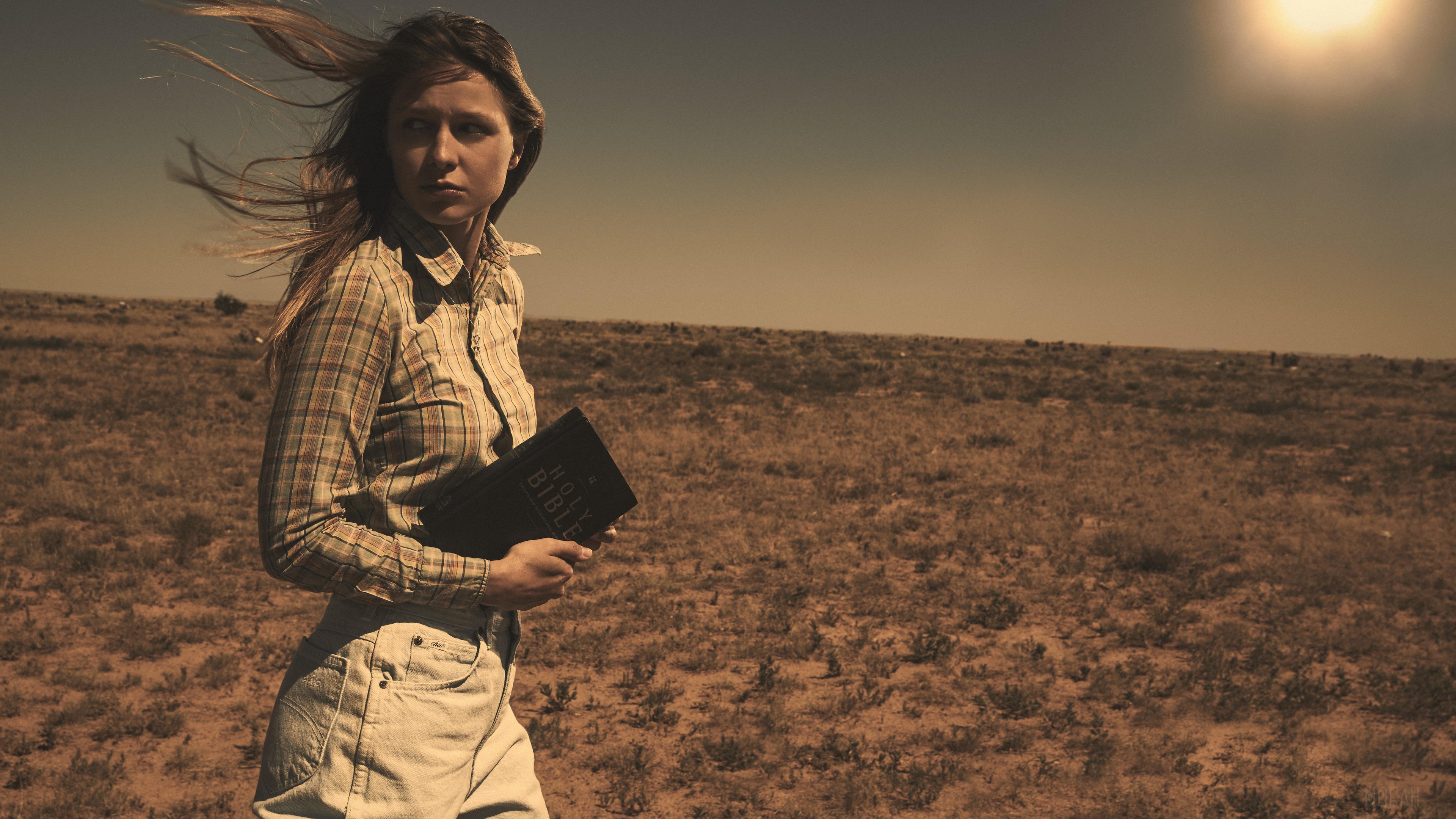 Melissa Benoist in a desert landscape holding a Bible HD Wallpaper