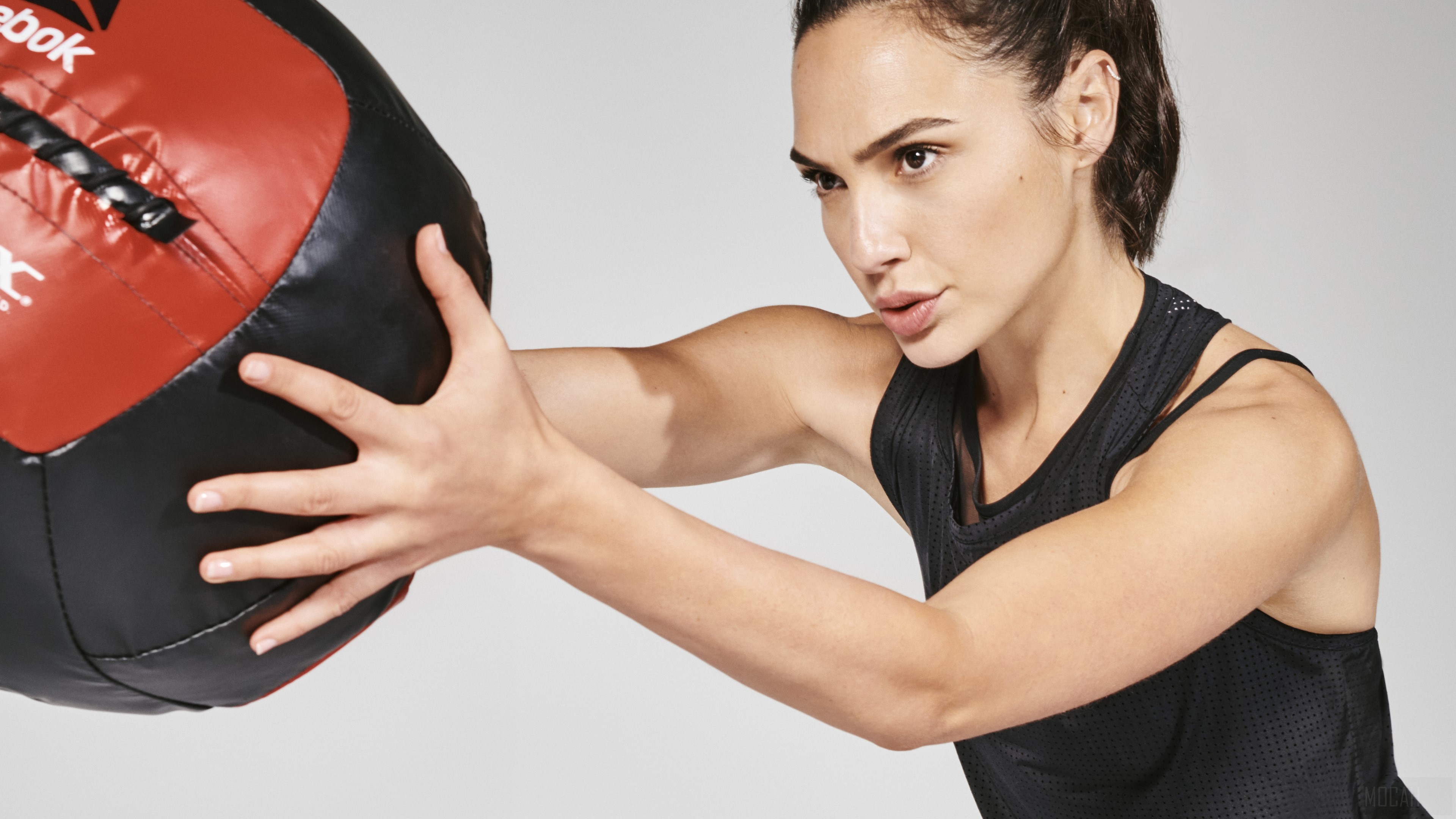 Gal Gadot holding a Reebok medicine ball HD Wallpaper