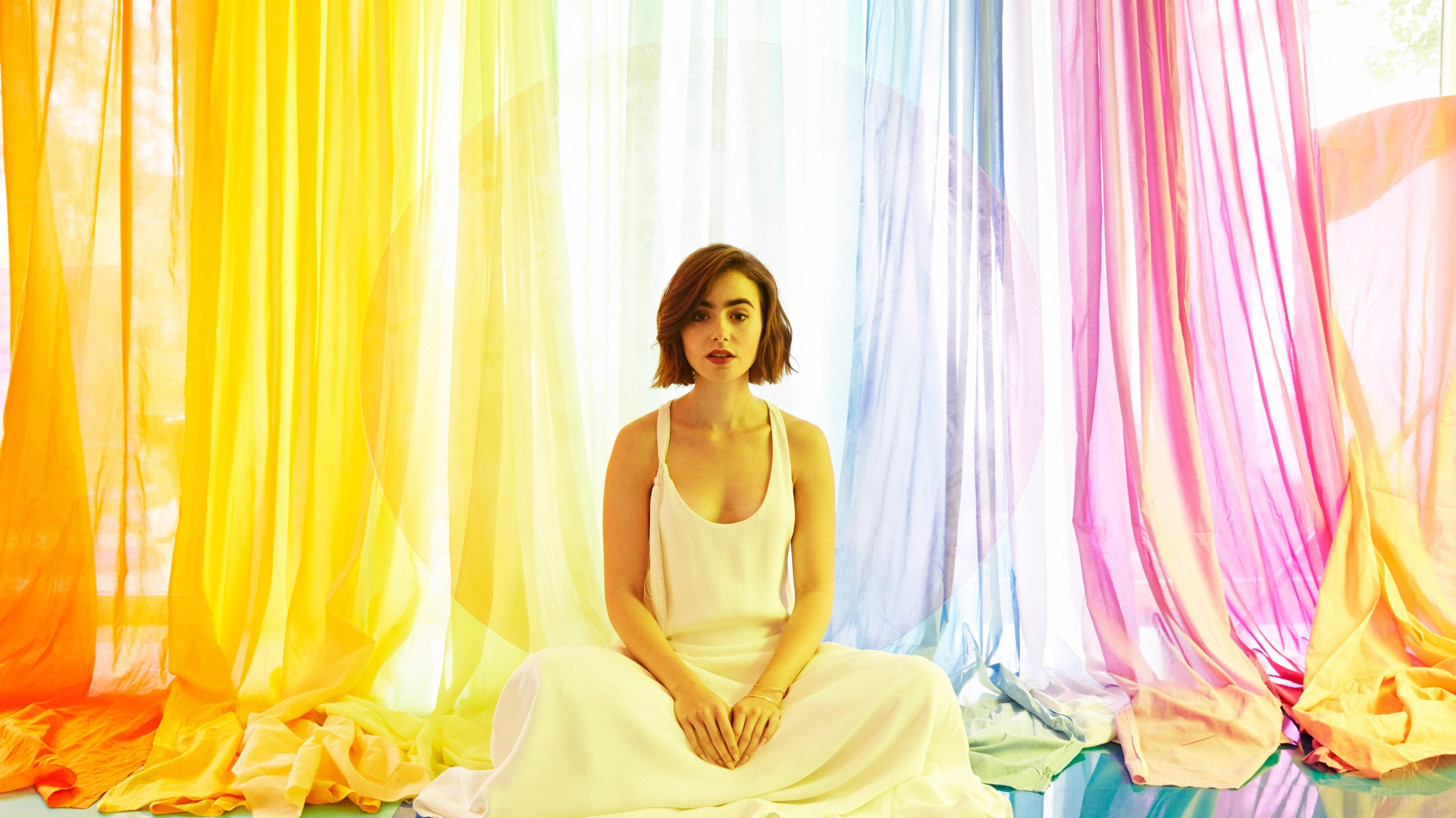 Lily Collins sitting in front of rainbow curtains 4K HD Wallpaper