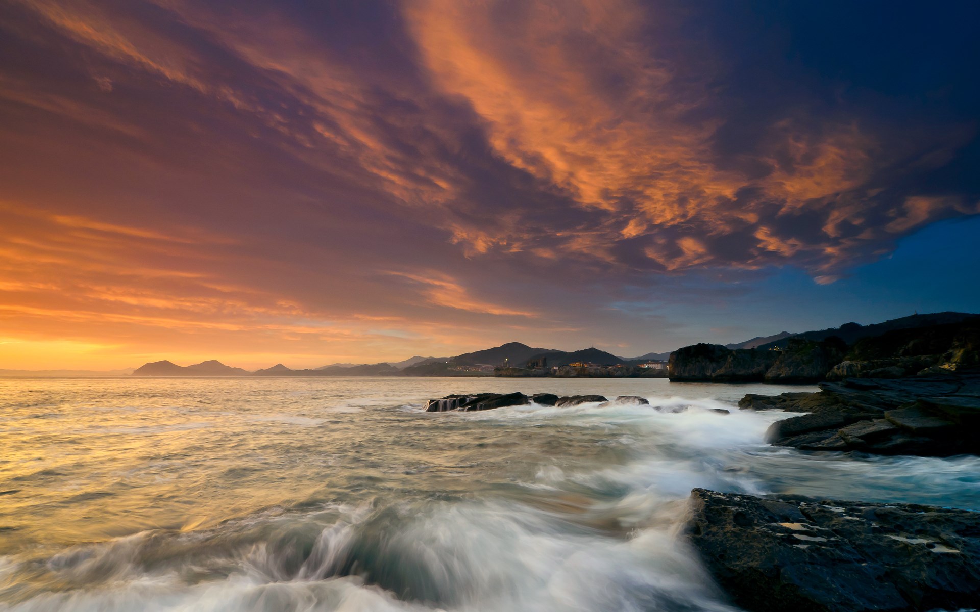 Sunset over the ocean with rocky shore HD Wallpaper