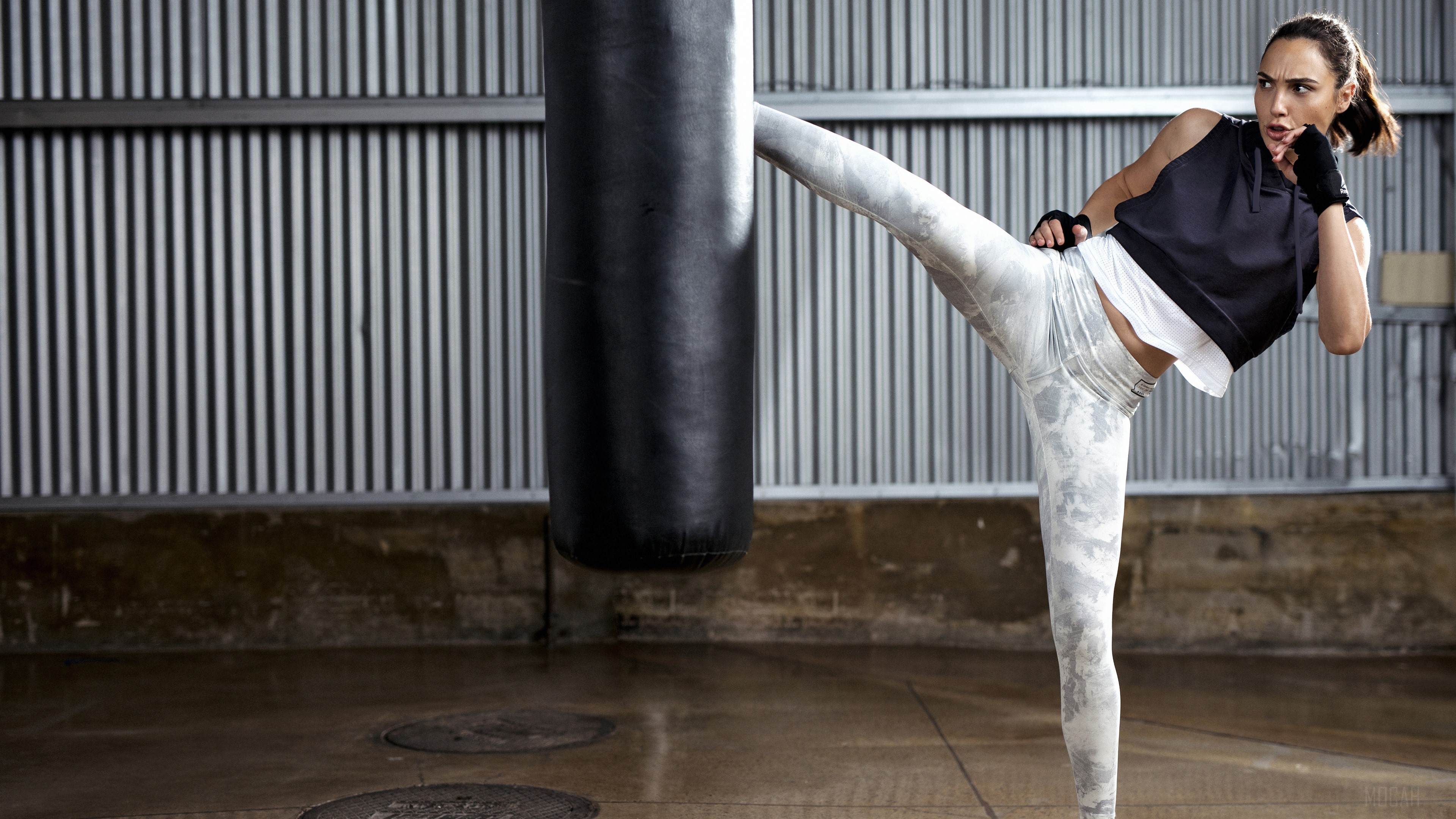 Gal Gadot practicing martial arts with a punching bag HD Wallpaper