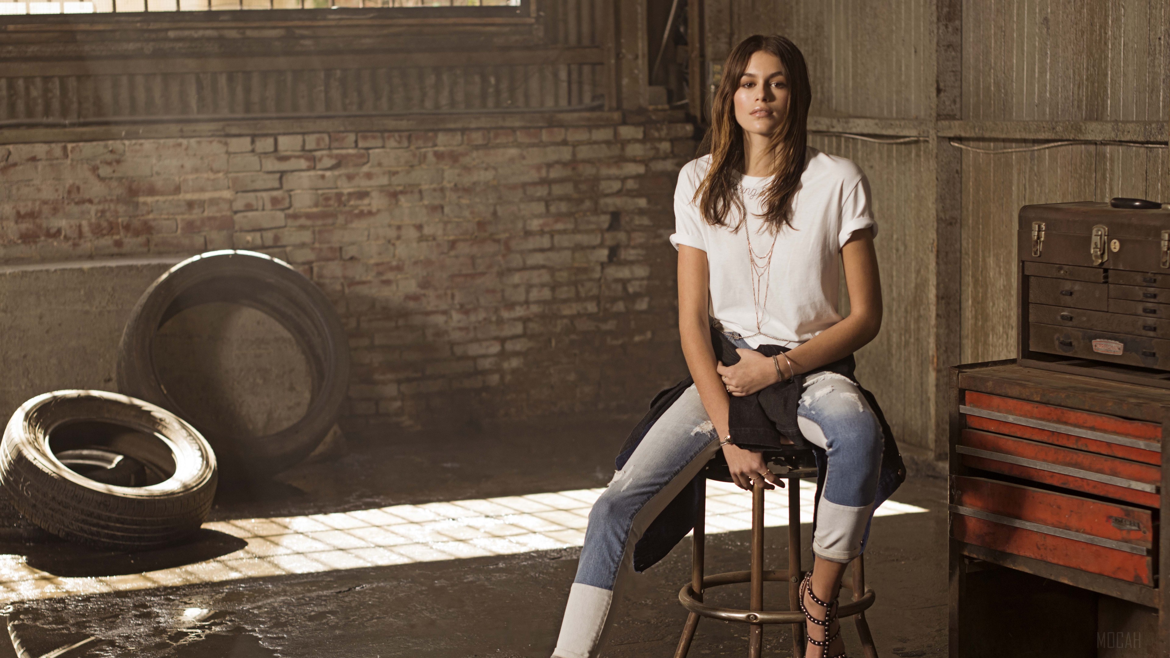 Kaia Gerber in a garage setting HD Wallpaper