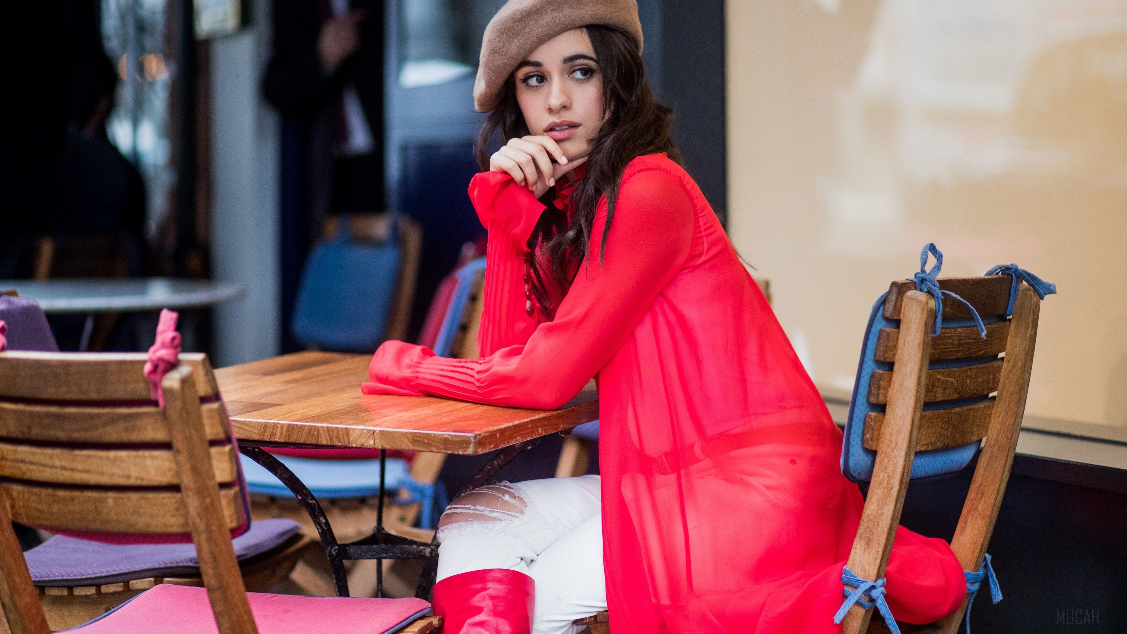 Camila Cabello sitting at a cafe table HD Wallpaper