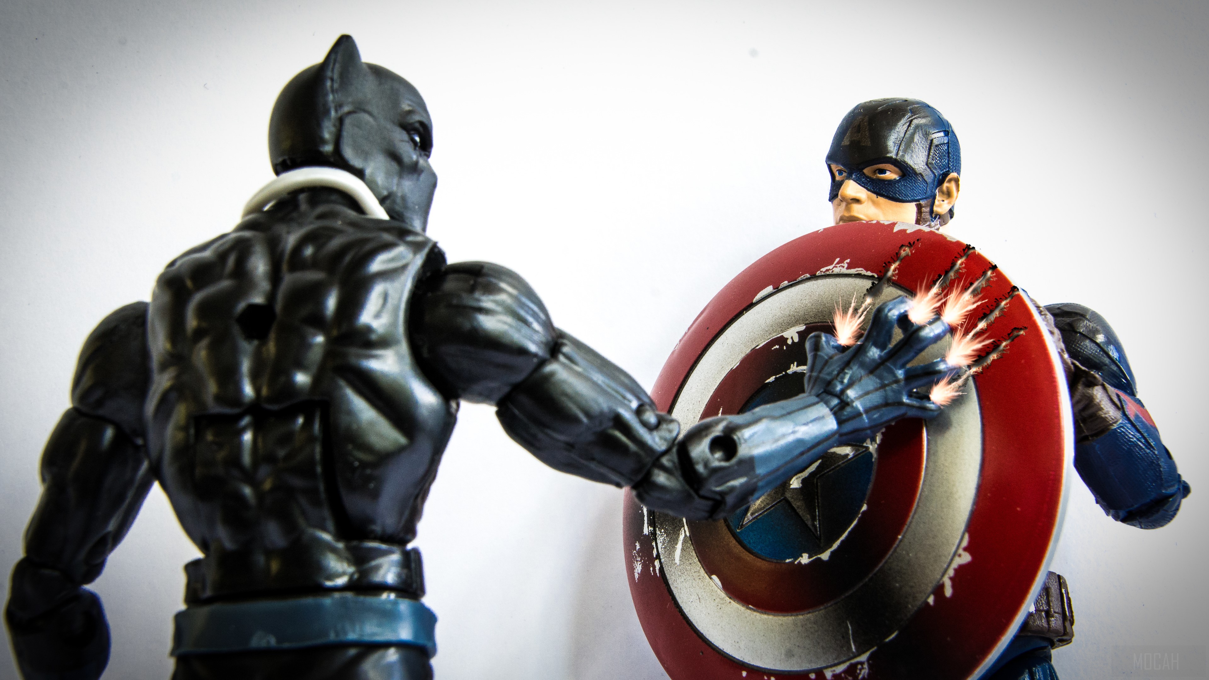 Black Panther and Captain America action figures fighting HD Wallpaper