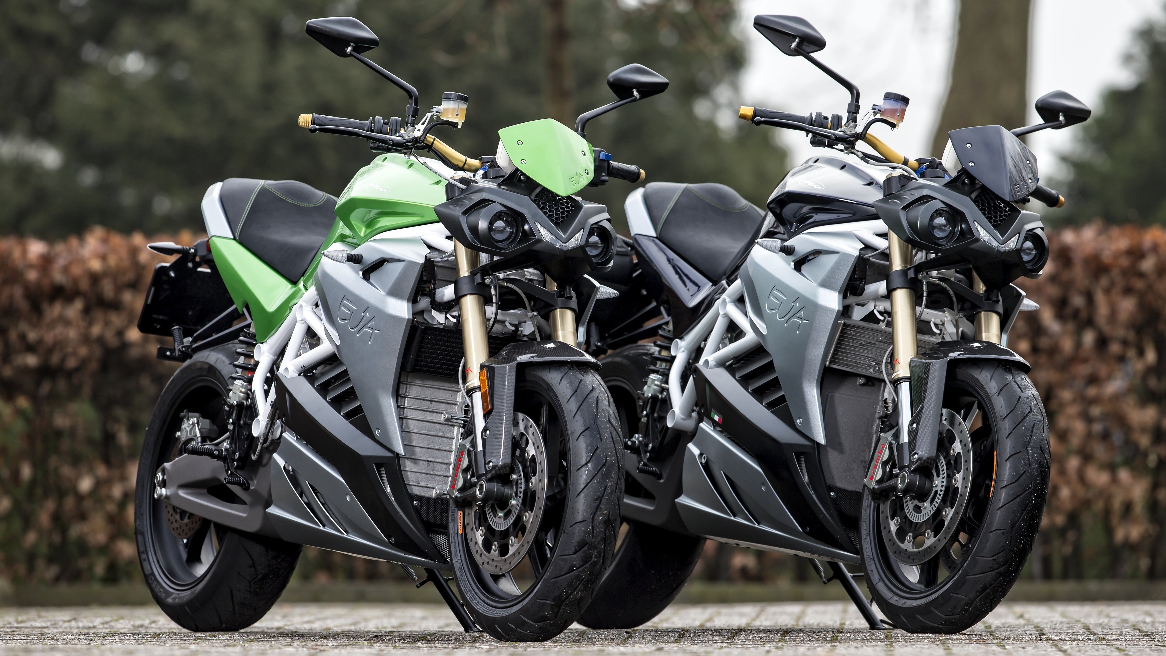 Two Energica electric motorcycles parked outdoors HD Wallpaper