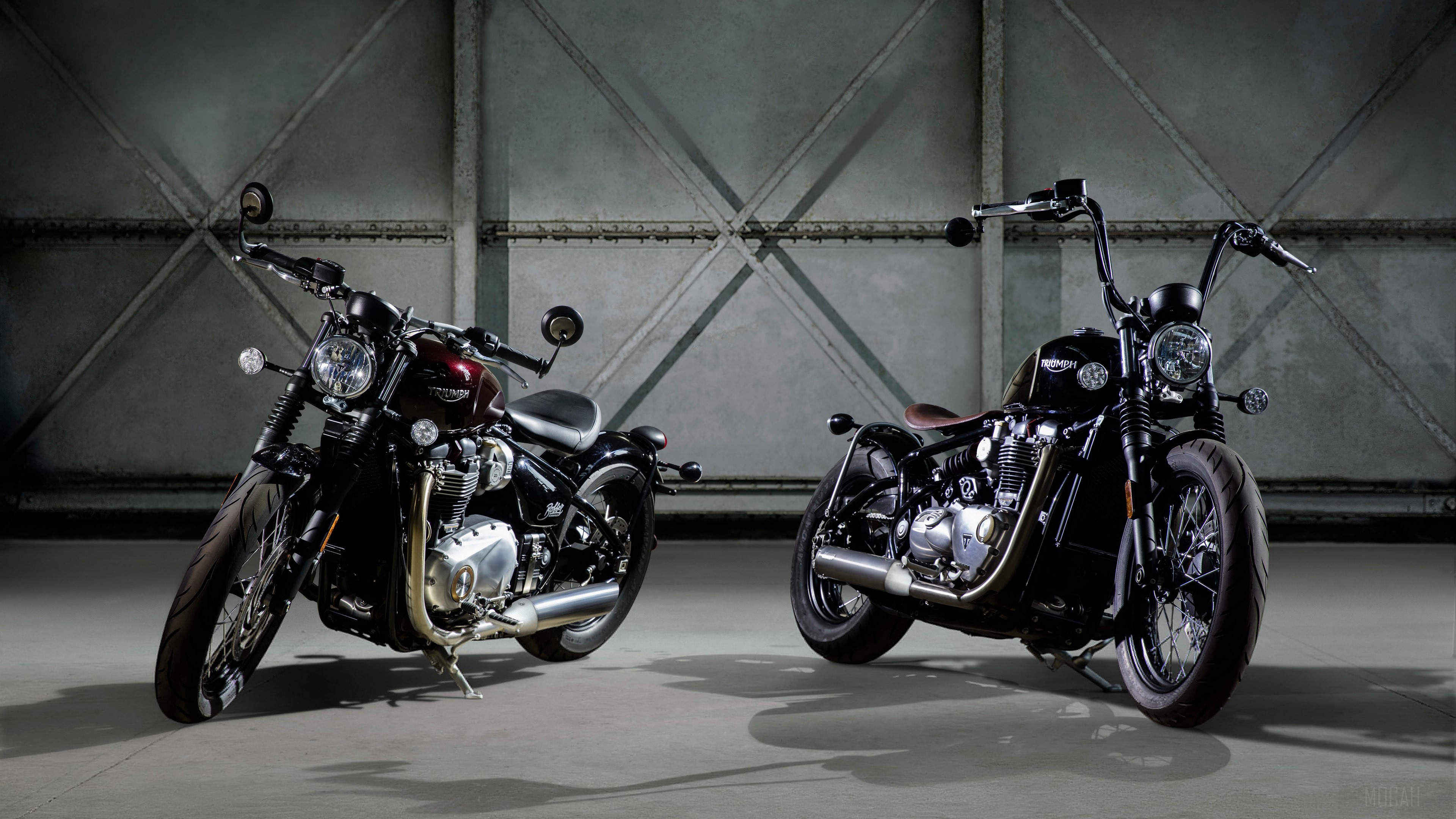 Two Triumph motorcycles in a garage HD Wallpaper