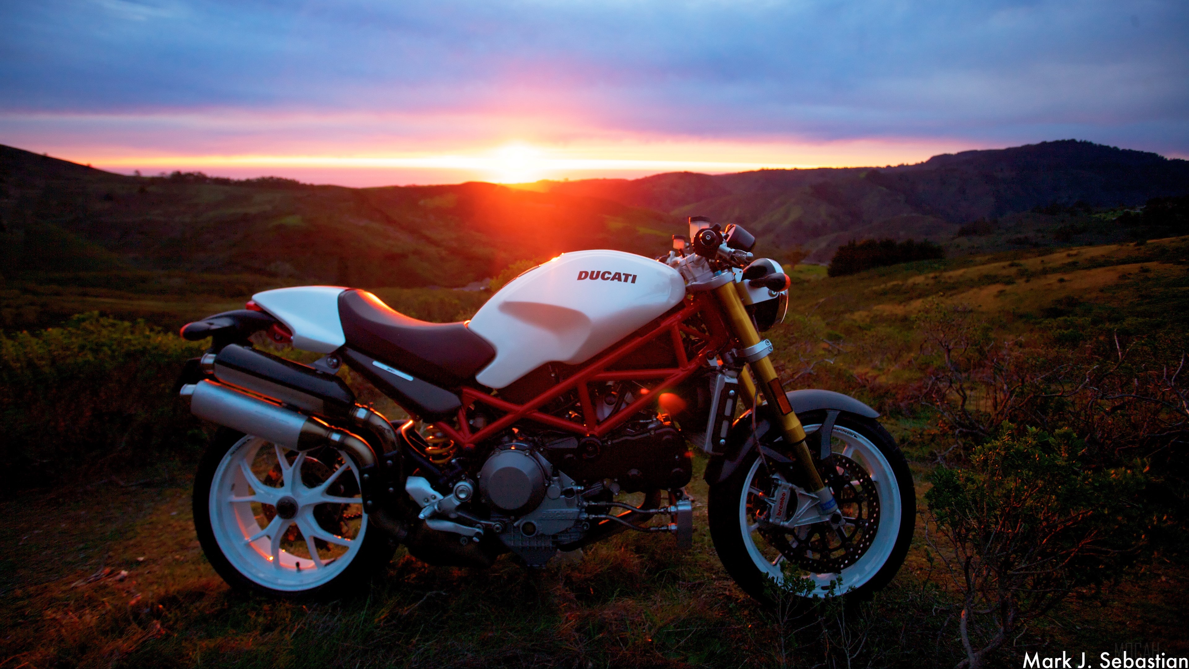 White Ducati motorcycle at sunset HD Wallpaper