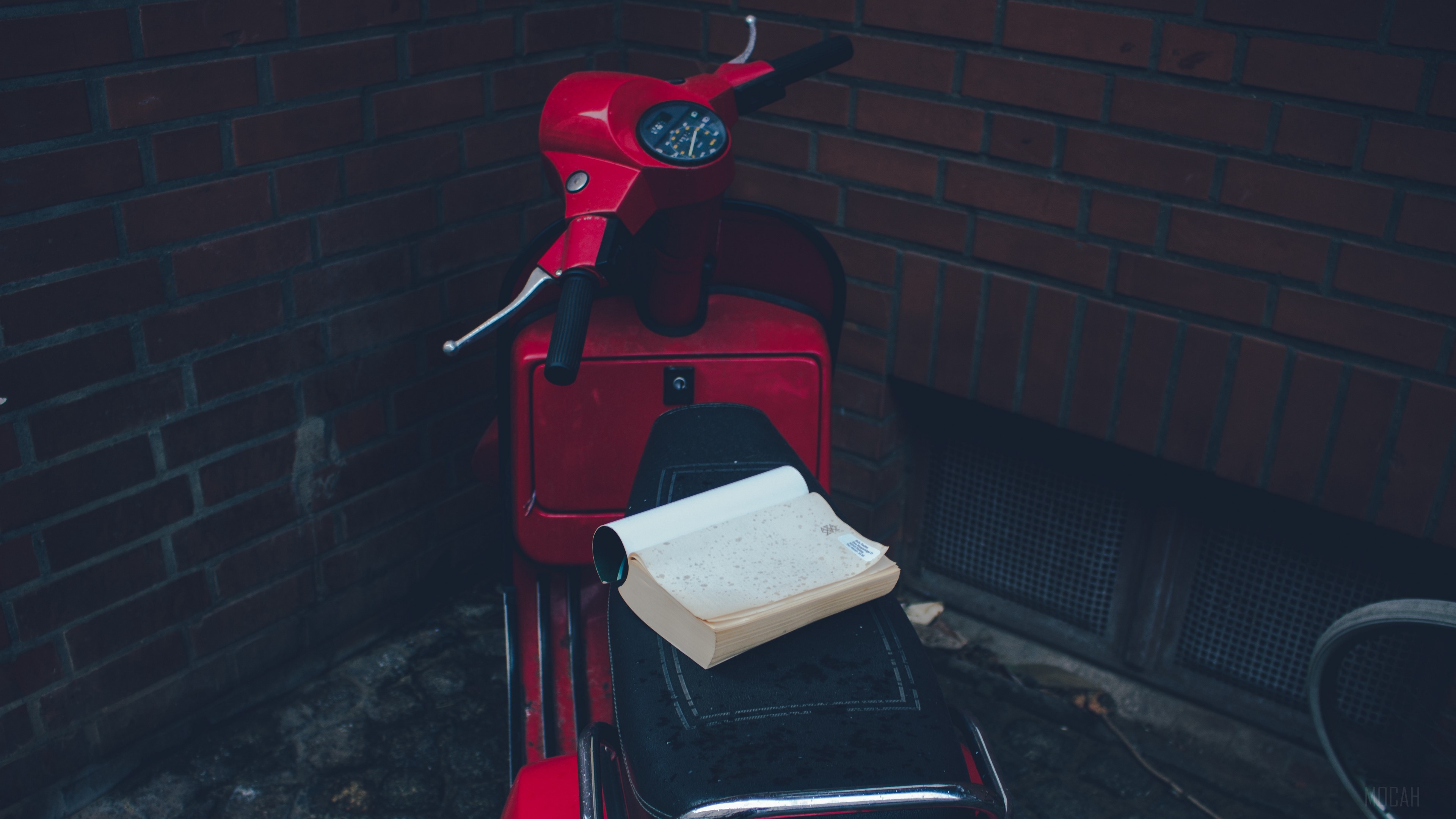 Red Vespa scooter with a book HD Wallpaper