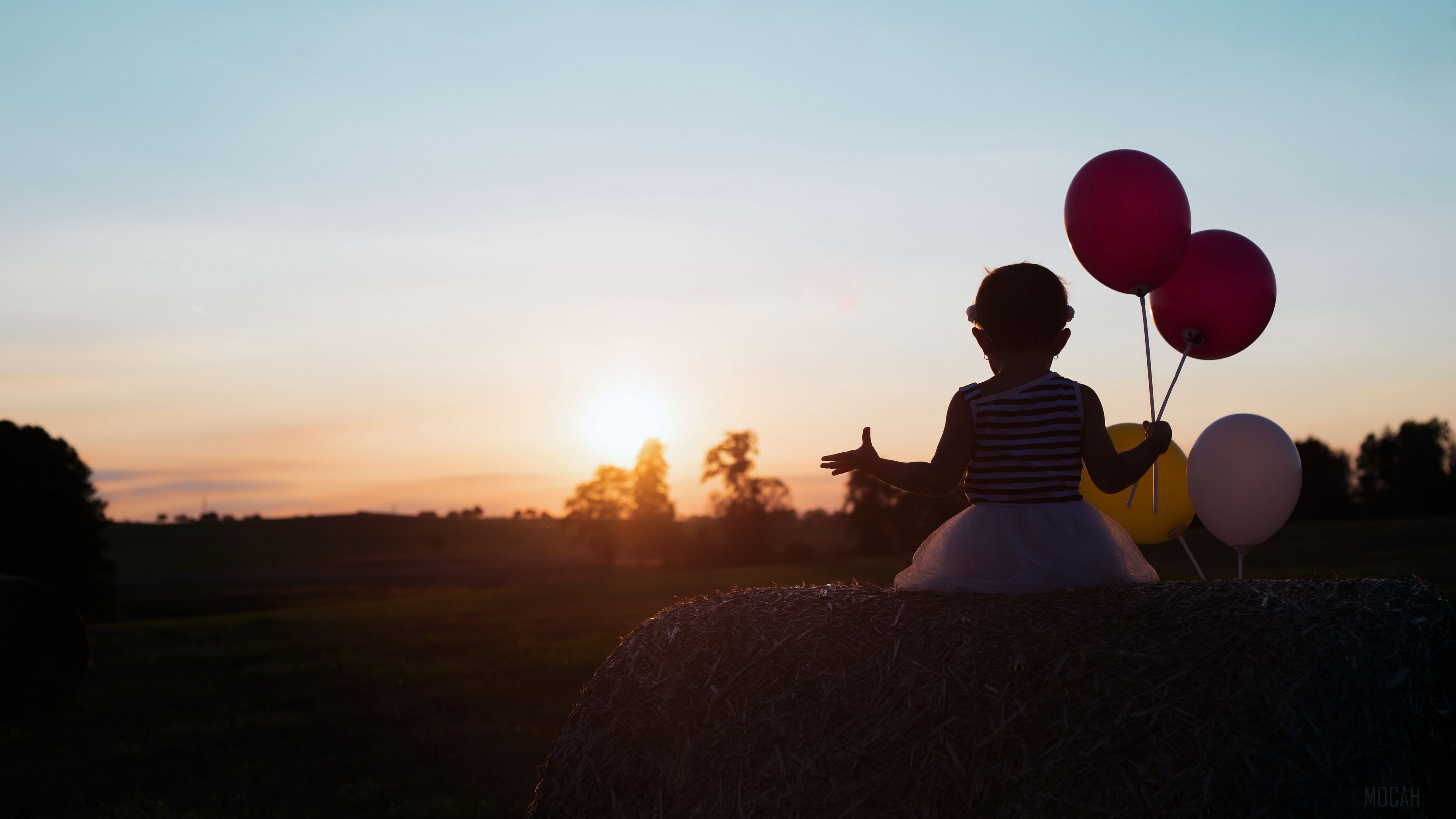 Child with balloons at sunset 4K HD Wallpaper