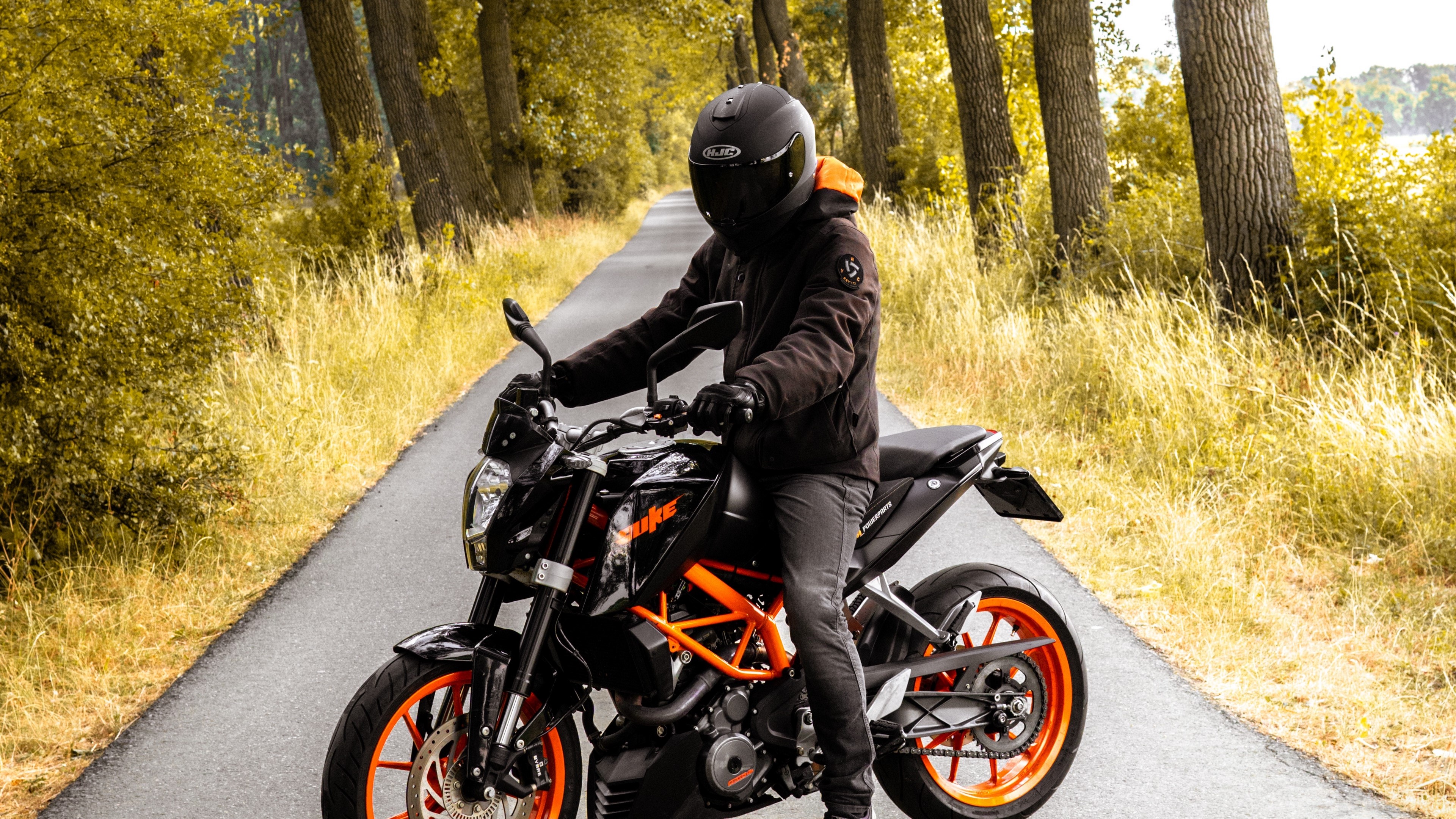 Motorcyclist on a KTM motorcycle on a road HD Wallpaper