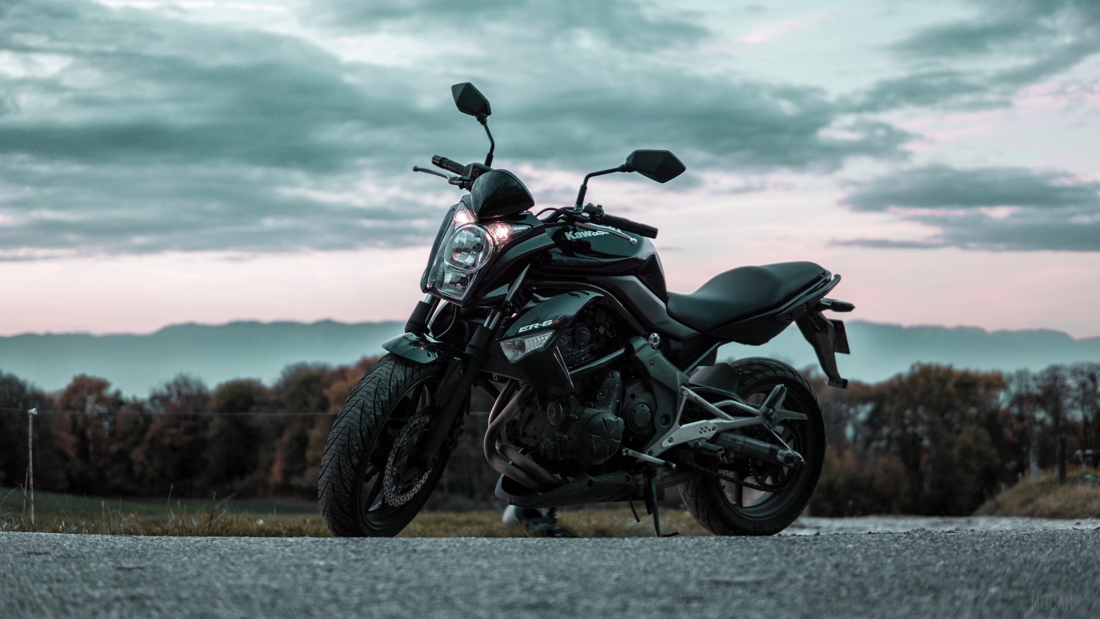 Black Kawasaki ER-6n motorcycle on a road HD Wallpaper