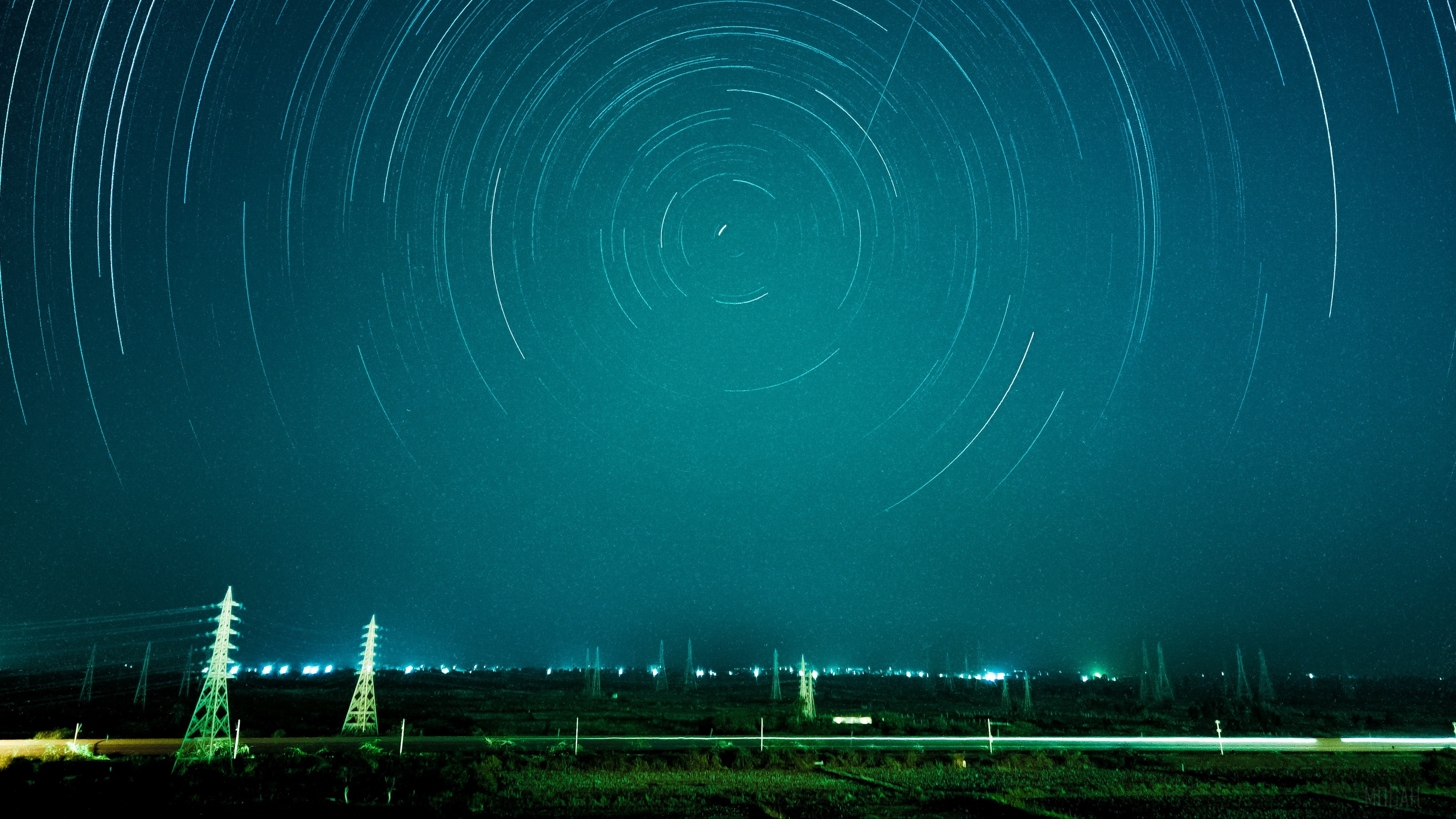Star trails over power lines at night HD Wallpaper