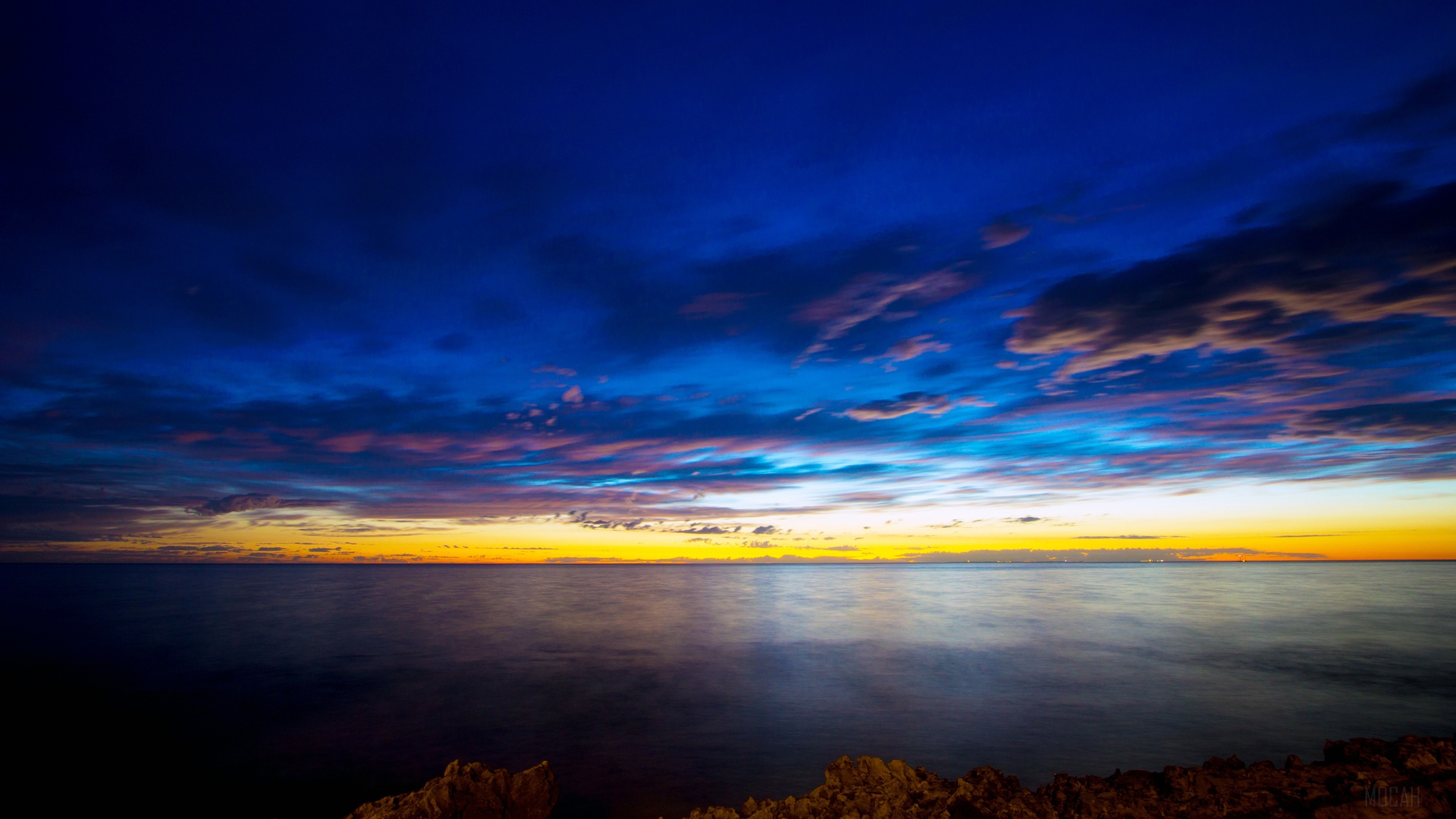 Sunset over the sea with dramatic clouds HD Wallpaper
