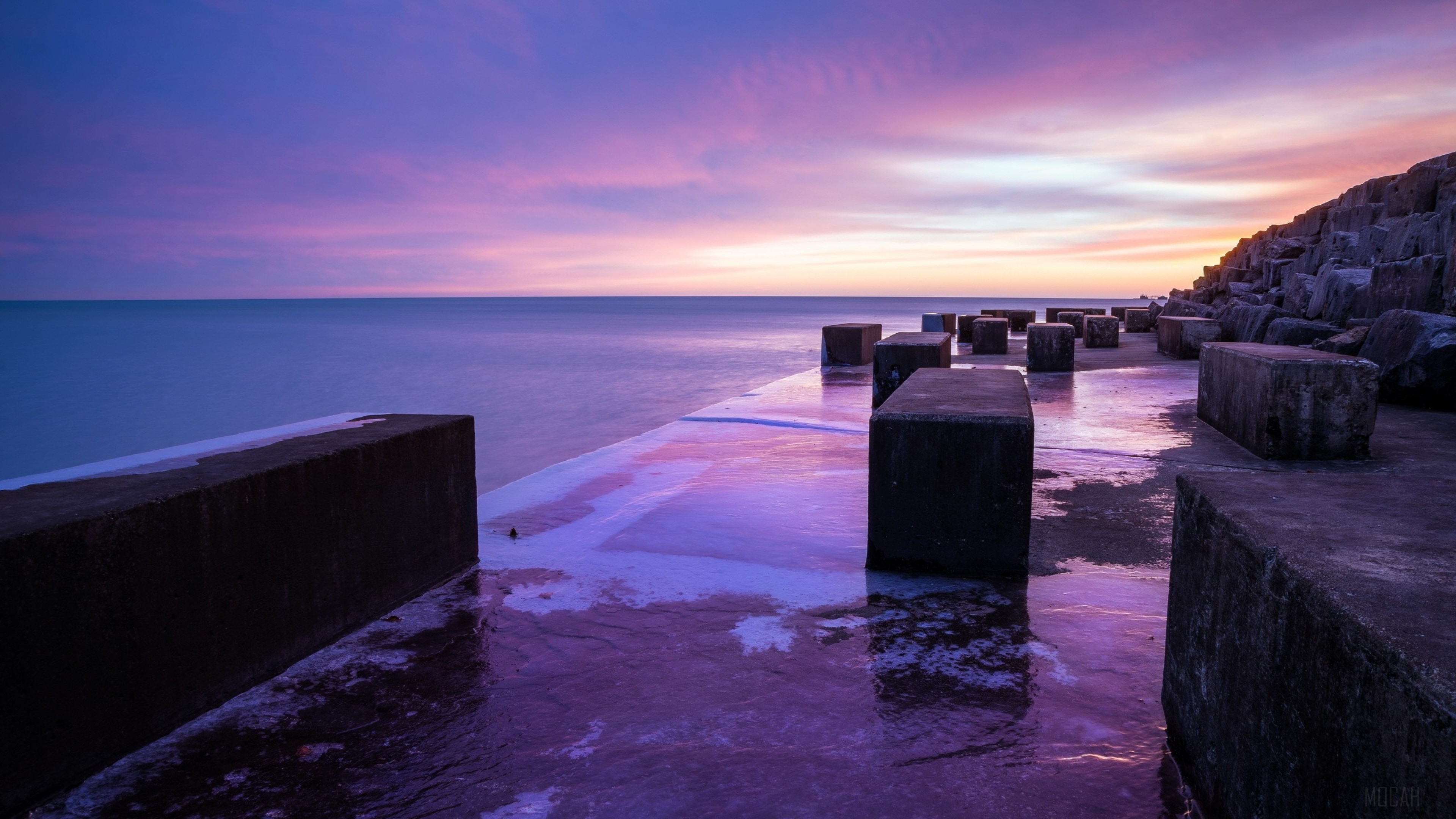 Concrete blocks on a beach at sunset HD Wallpaper