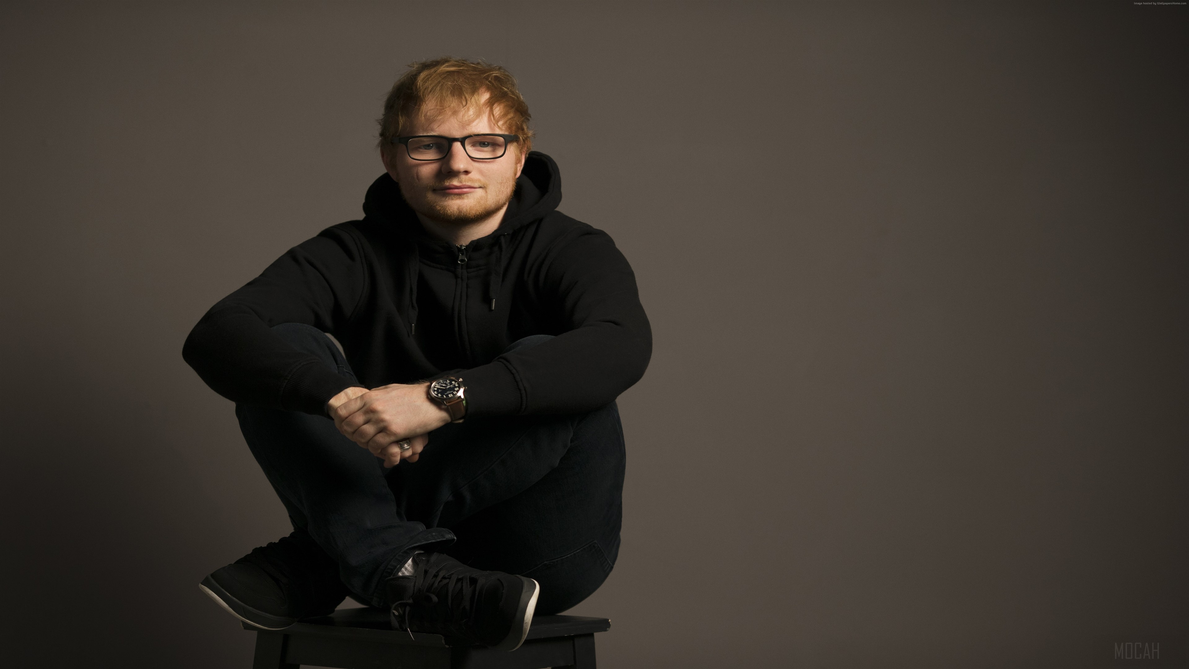 Ed Sheeran sitting cross-legged HD Wallpaper
