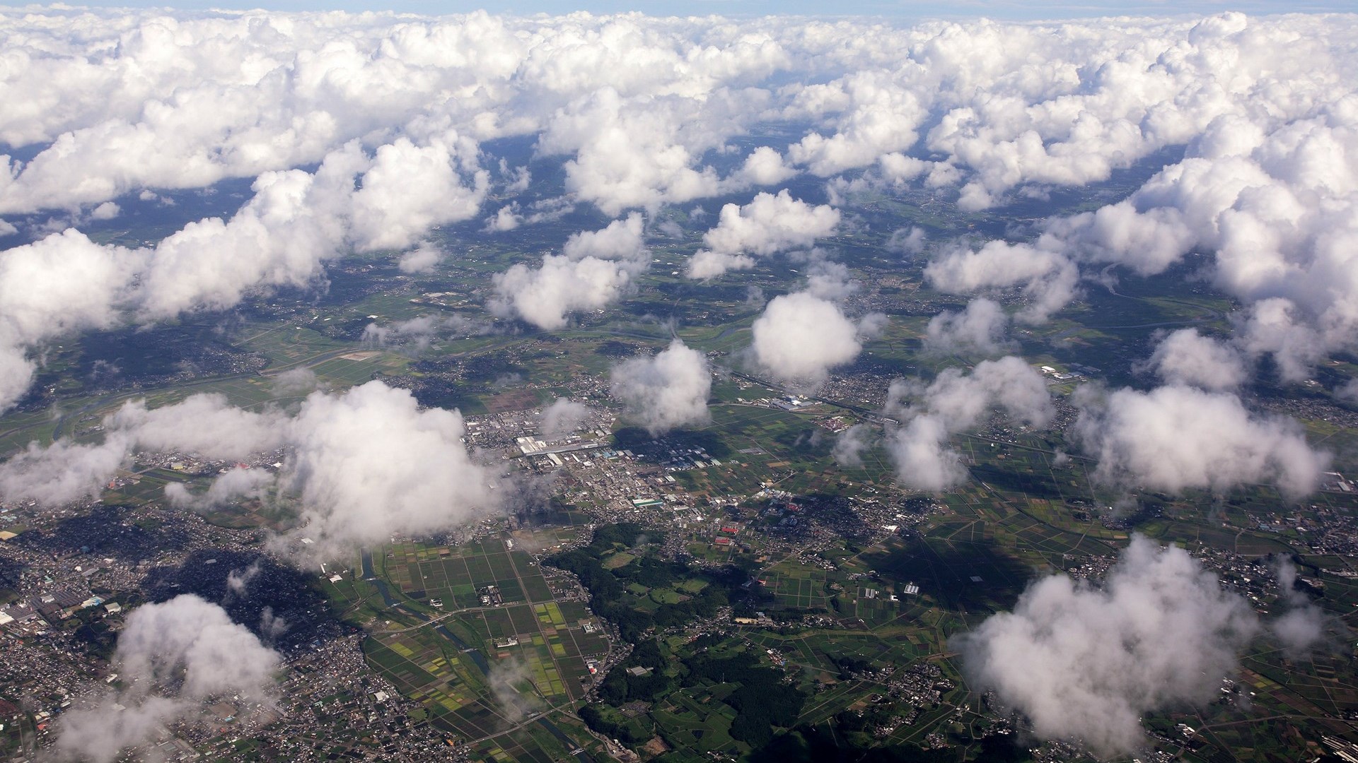 Aerial view of clouds over a landscape HD Wallpaper