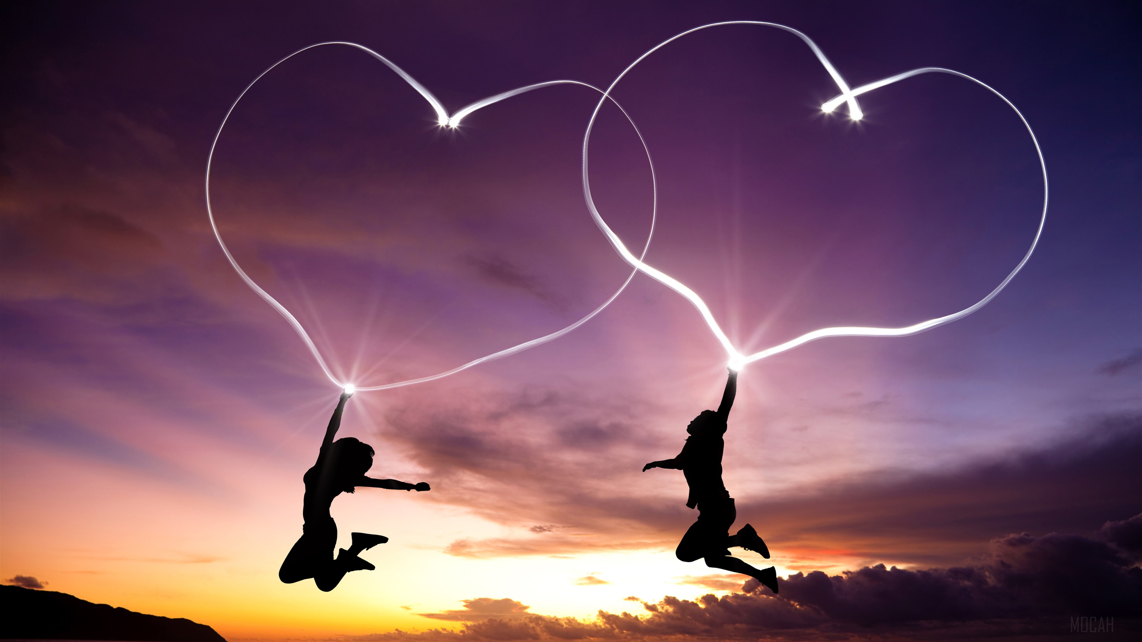 Couple drawing love hearts in the sky at sunset HD Wallpaper