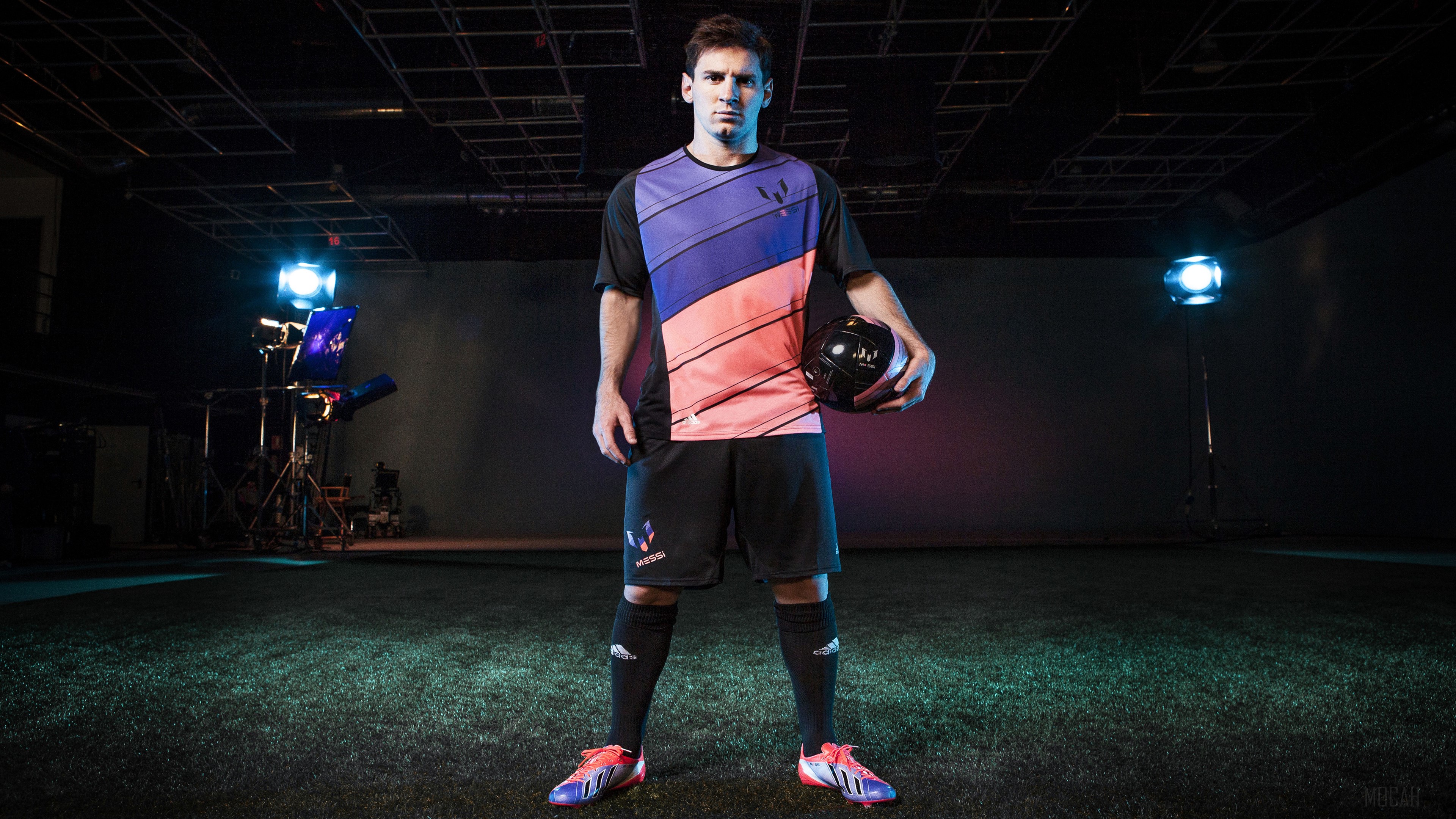 Lionel Messi in Adidas uniform holding a soccer ball HD Wallpaper