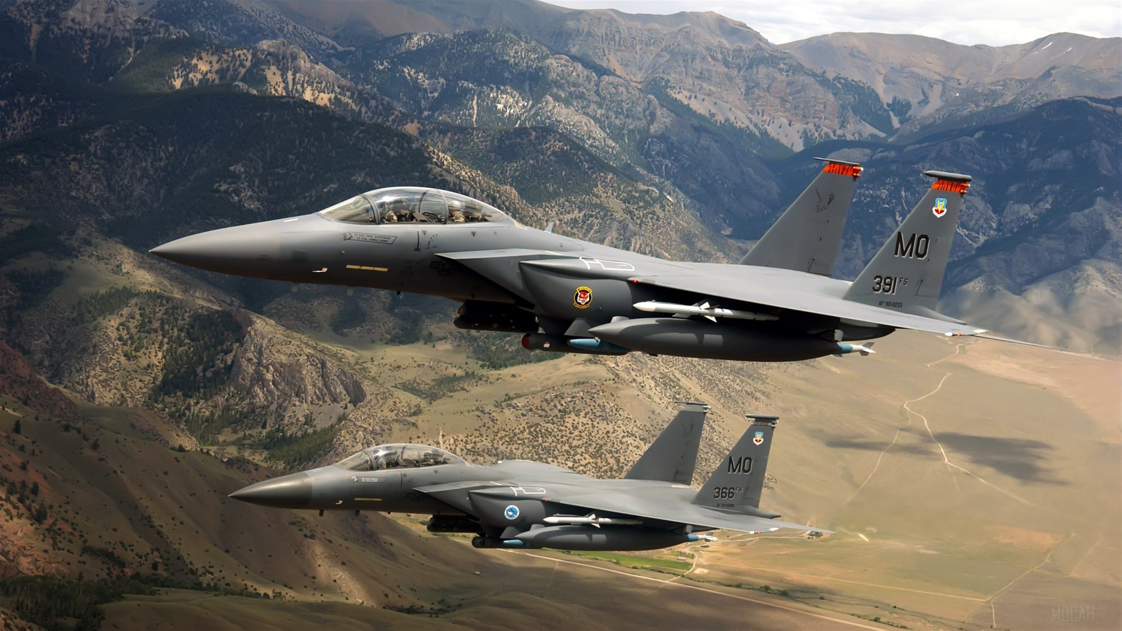 Two US Military F-15 fighter jets flying over mountains 4K HD Wallpaper