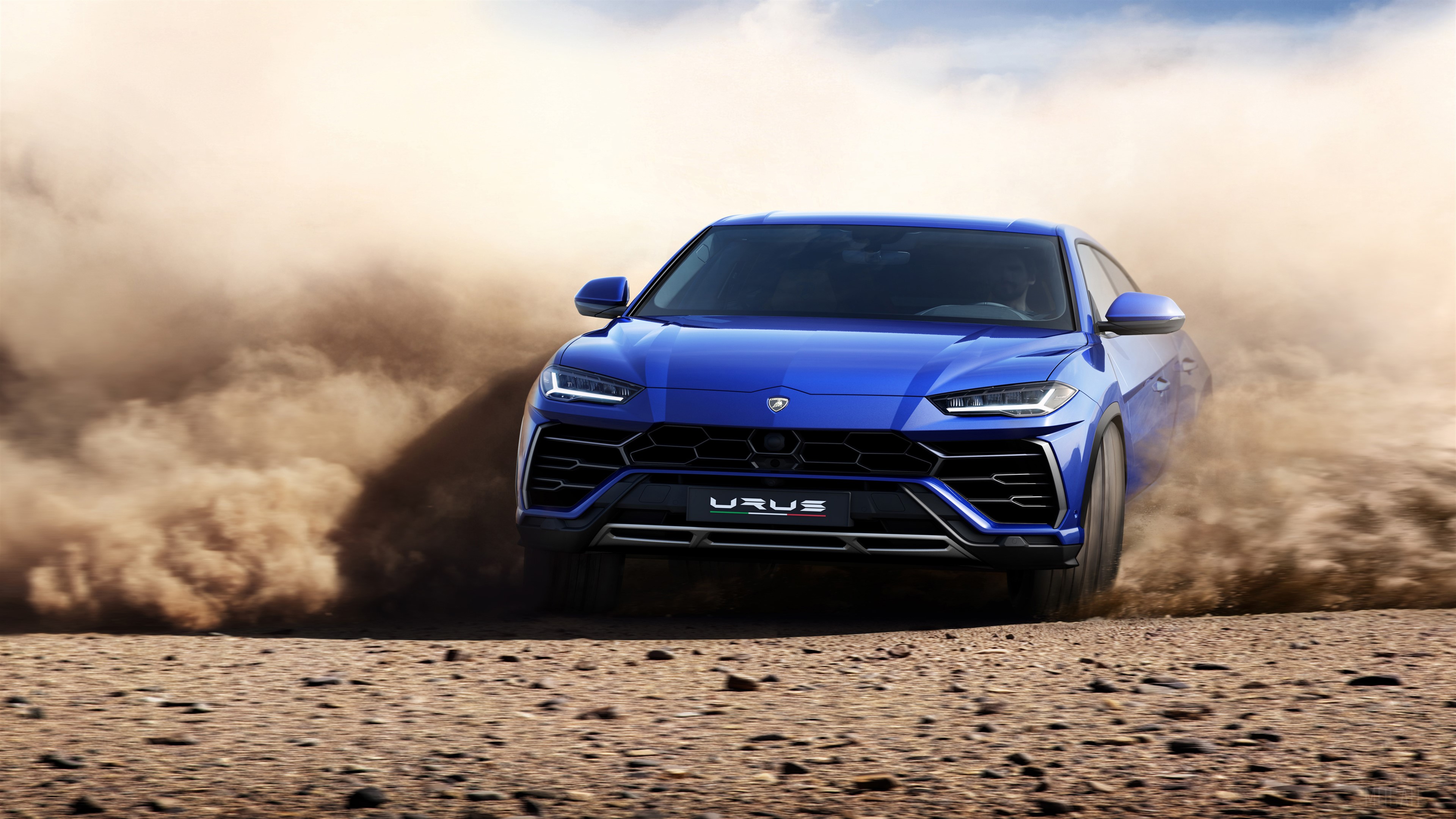 Blue Lamborghini Urus driving off-road HD Wallpaper