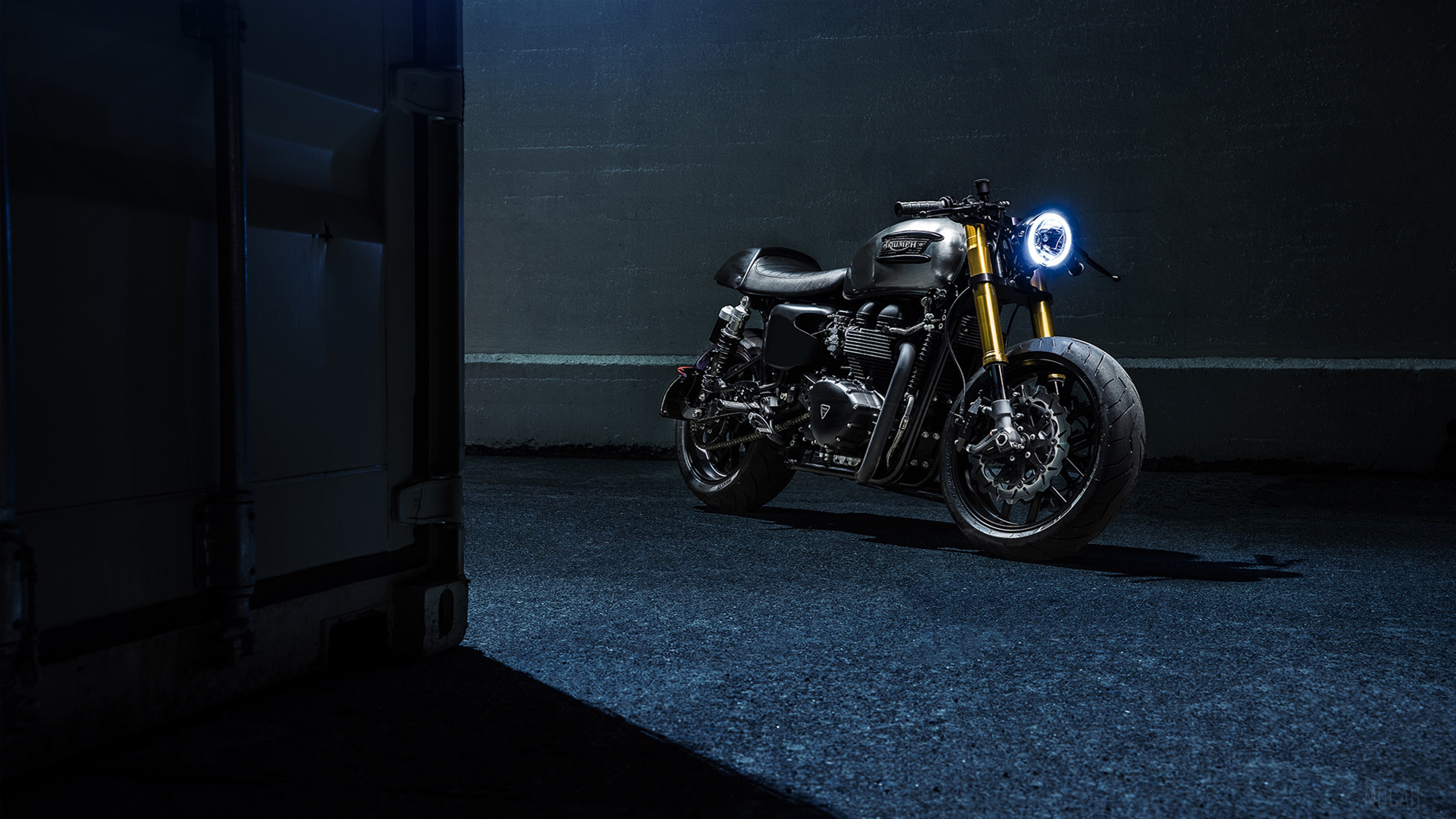 Triumph Bonneville motorcycle with glowing headlight HD Wallpaper