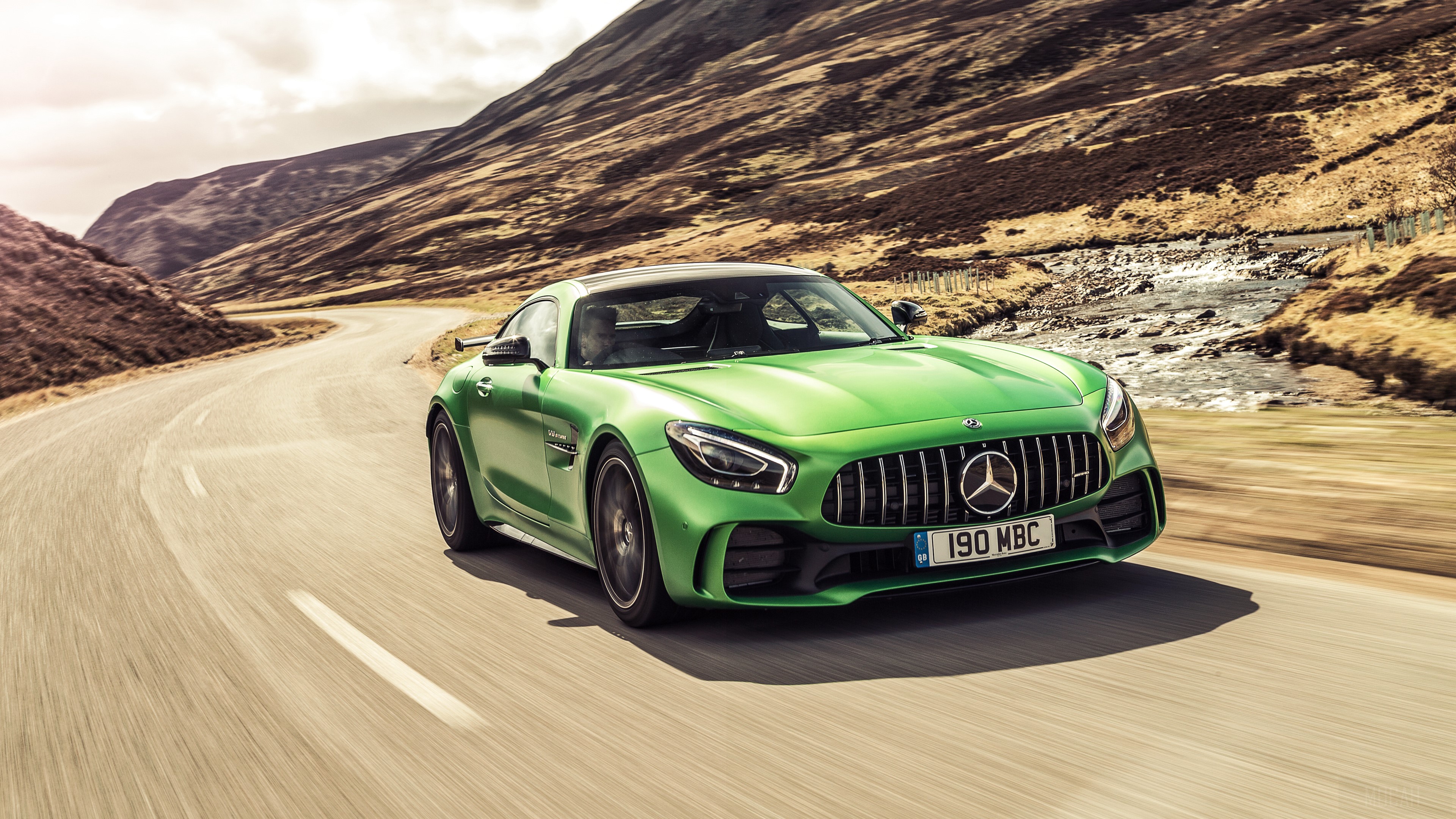 Green Mercedes AMG GT R driving on a winding road HD Wallpaper