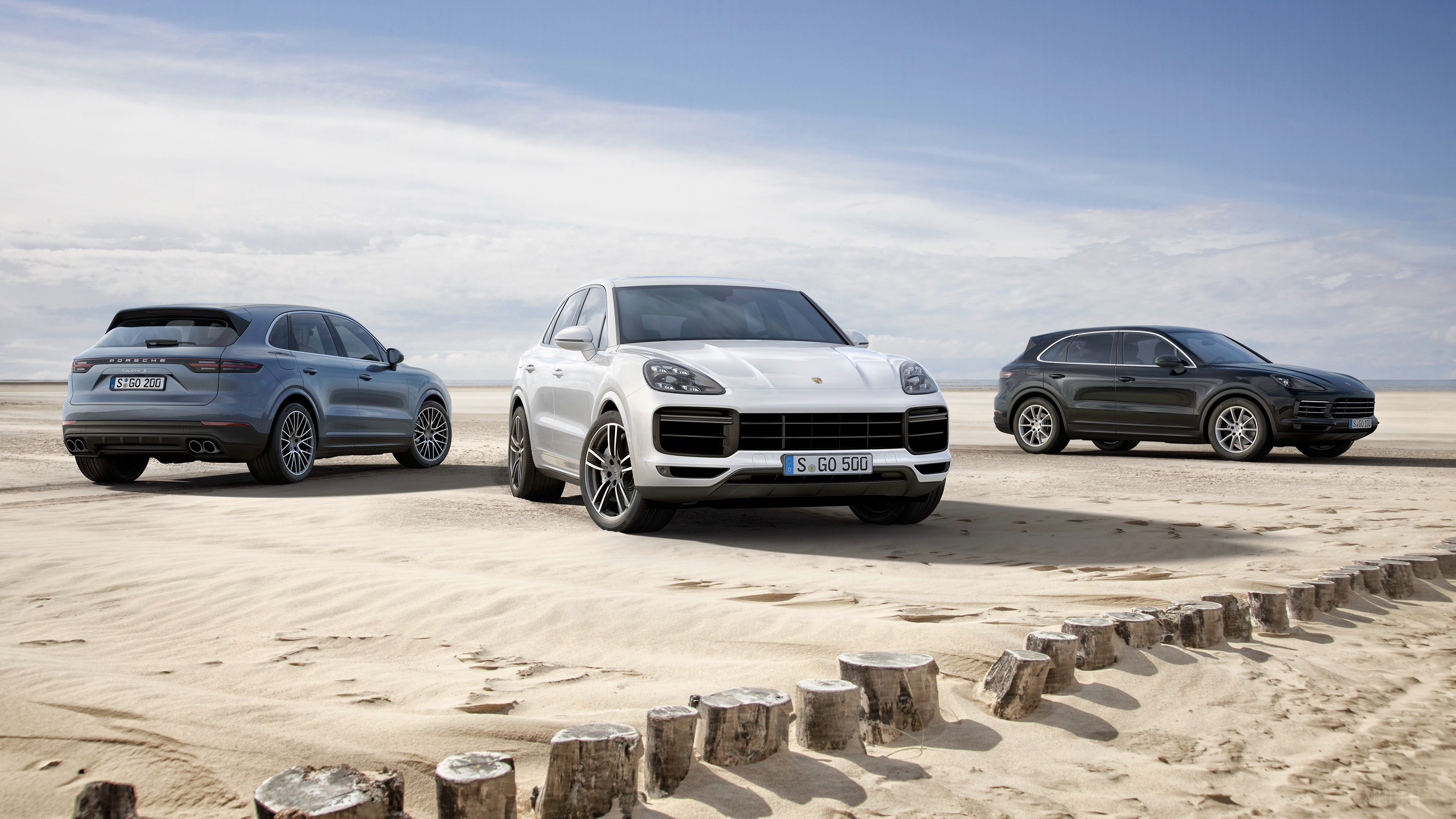 Three Porsche Cayenne SUVs on a Beach HD Wallpaper