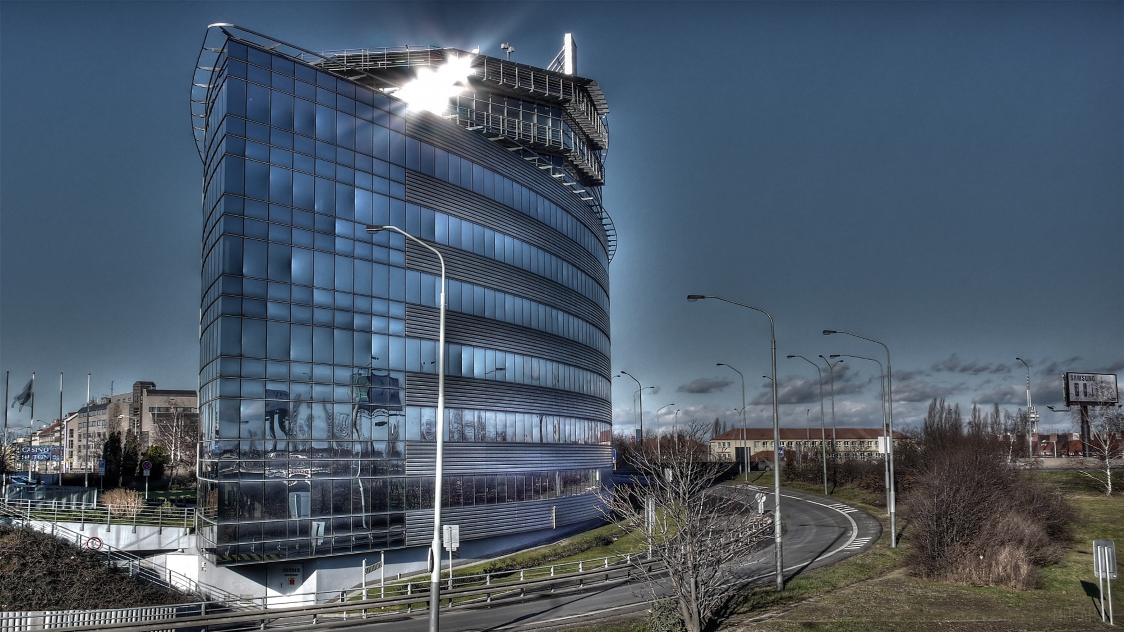 Modern glass building with a helipad HD Wallpaper
