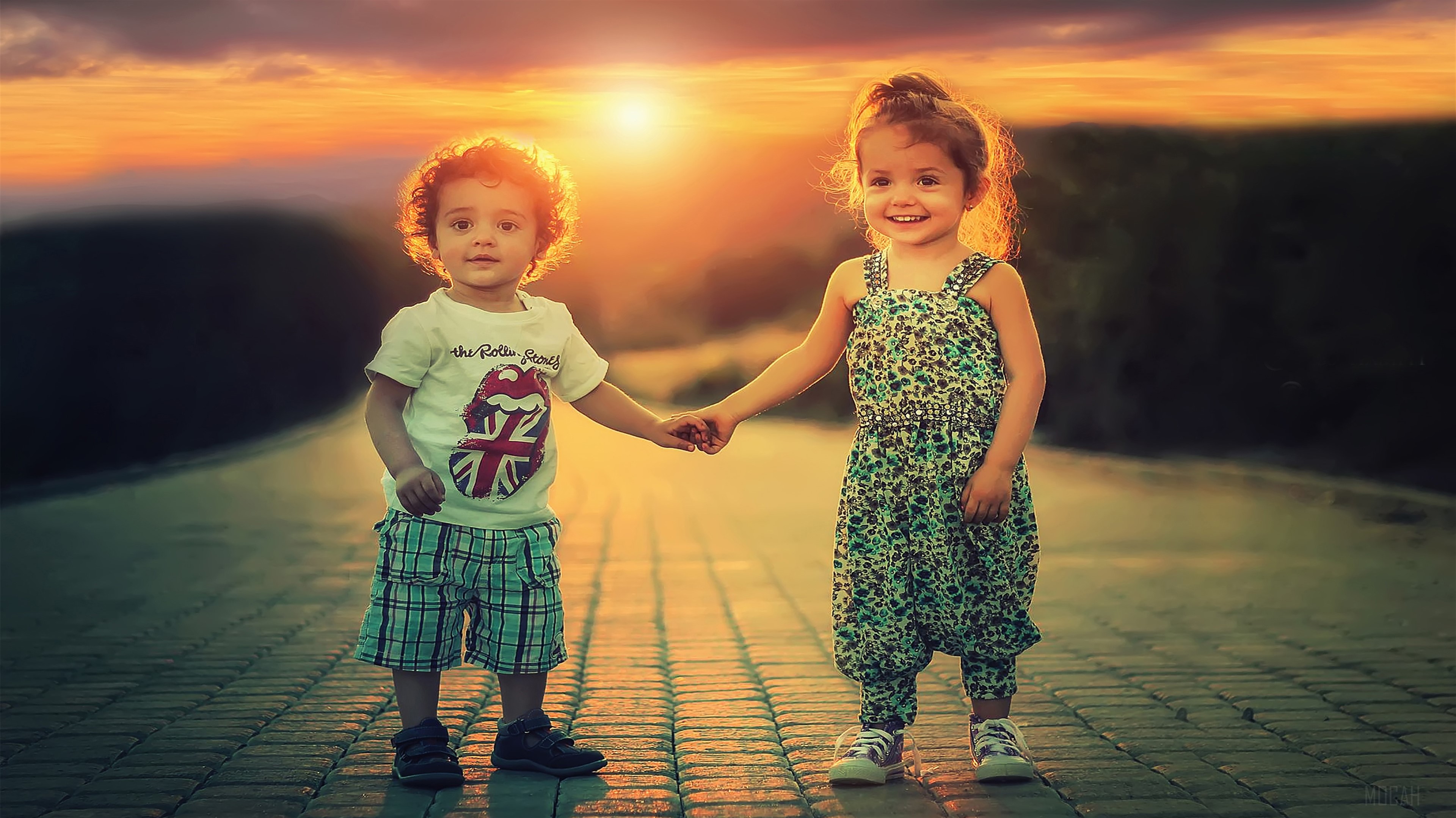 Two happy children holding hands at sunset 4K HD Wallpaper