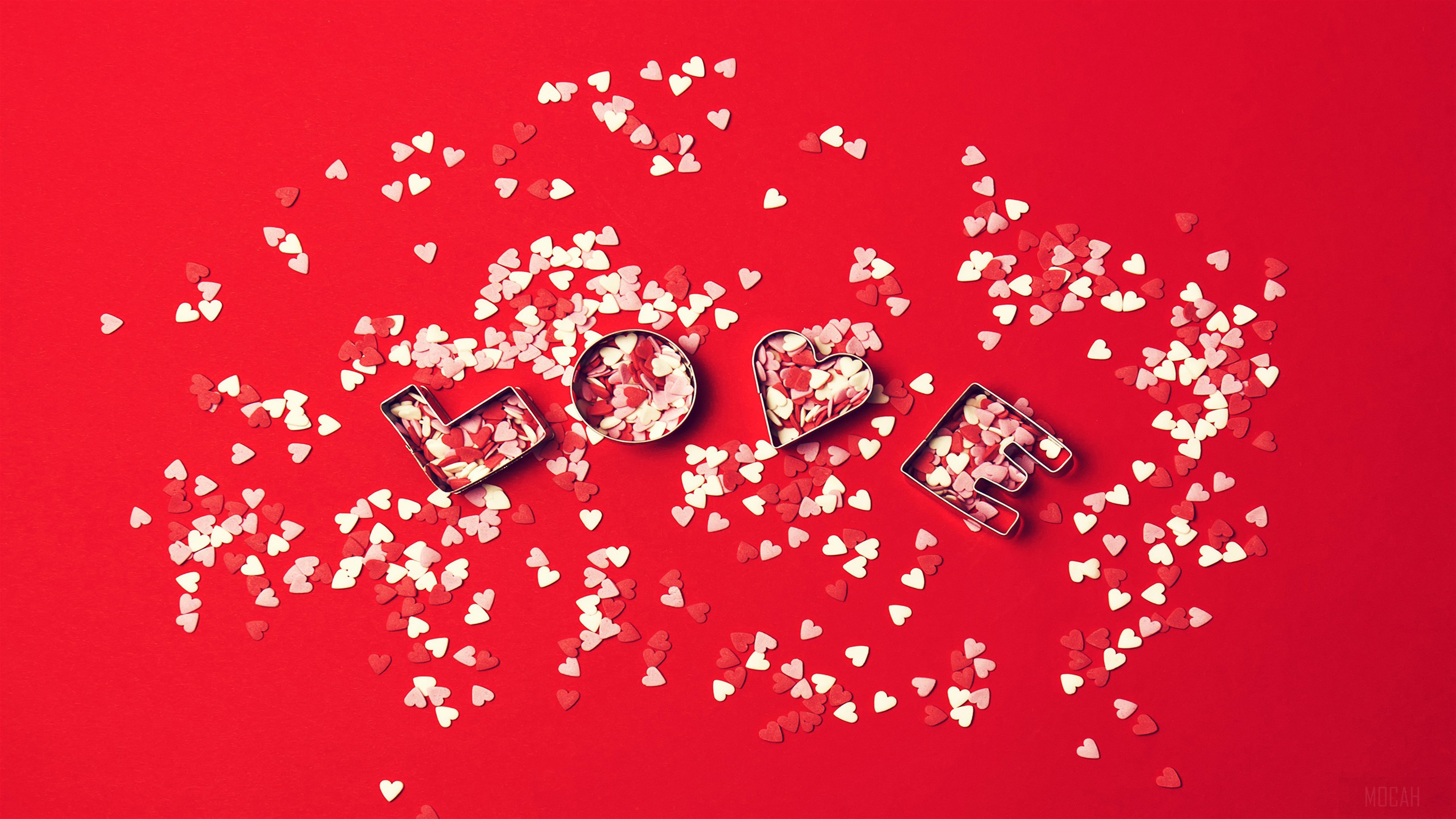 Love hearts cookie cutters on red background 4K HD Wallpaper