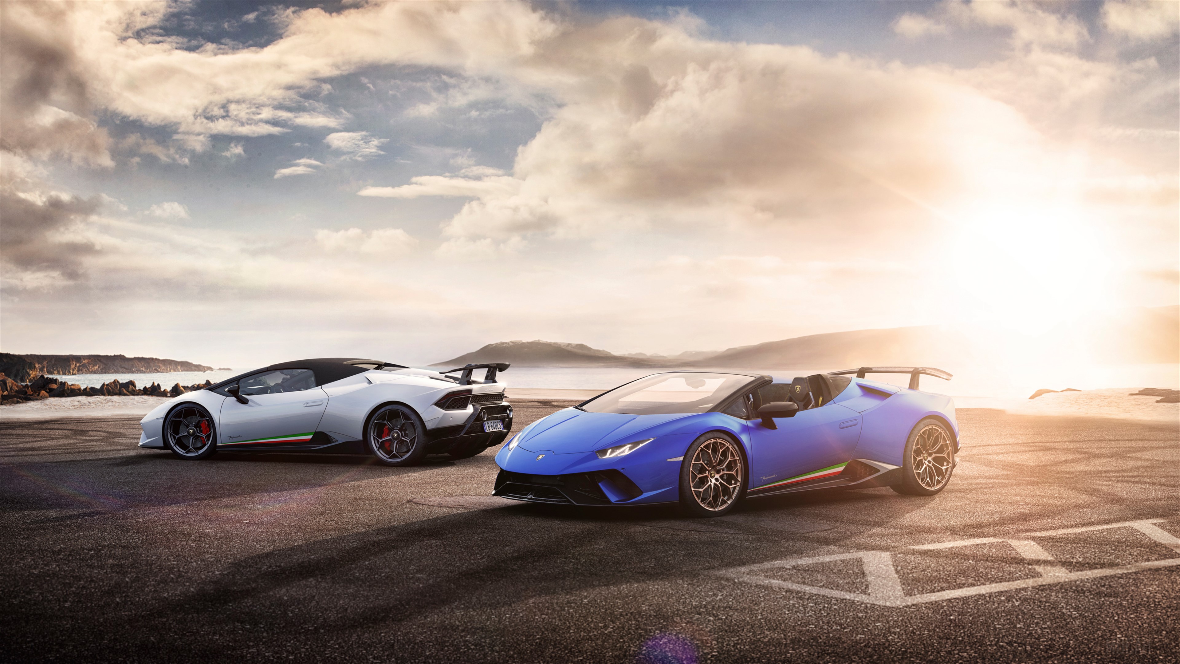 Two Lamborghini Huracan Performante Spyders on a beach road HD Wallpaper