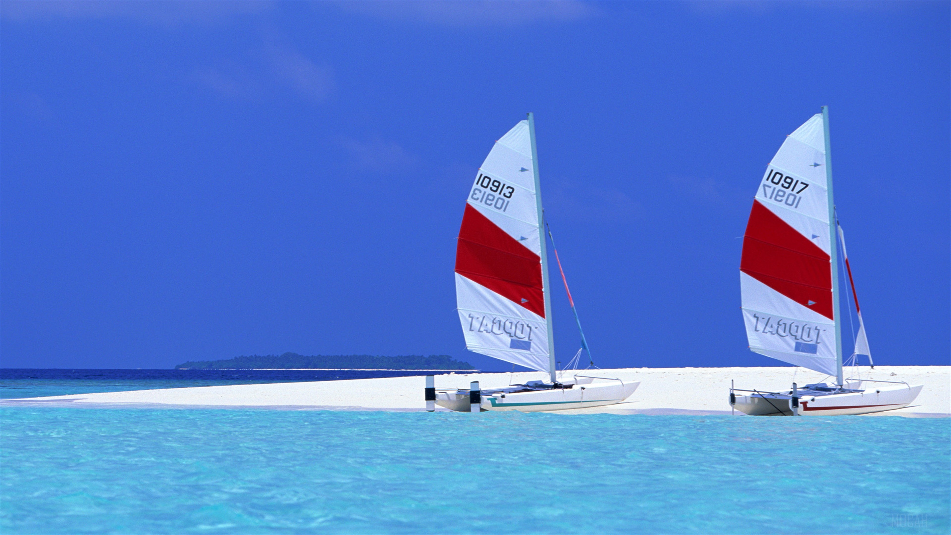 Two sailboats on a tropical beach with blue sky HD Wallpaper