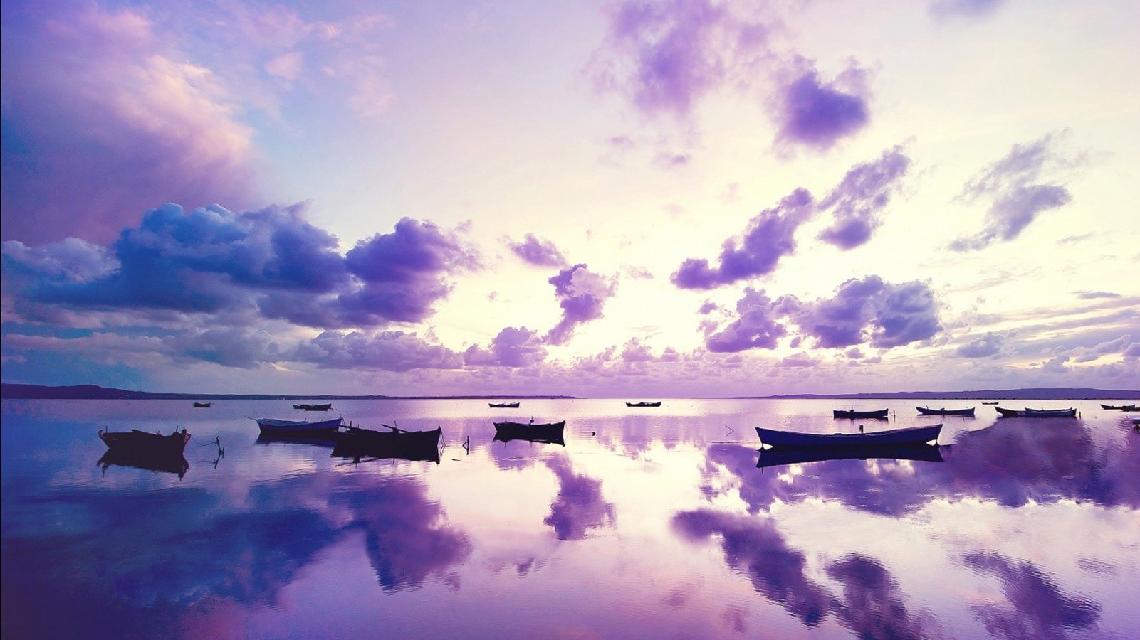 Boats on a calm lake at sunset with purple clouds HD Wallpaper