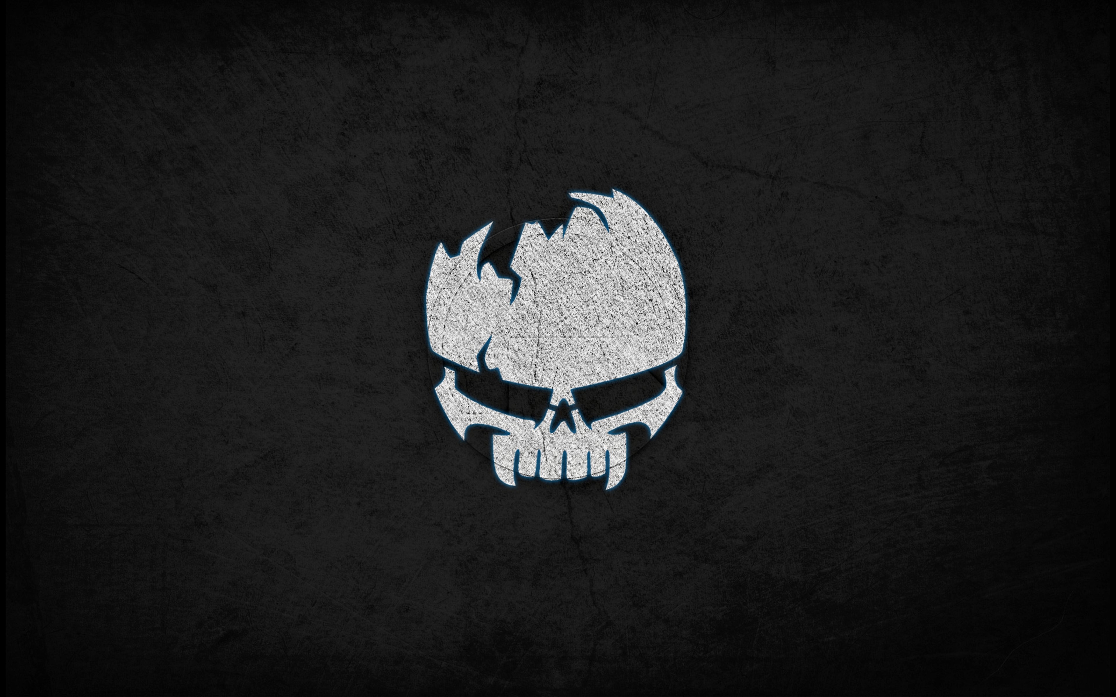 Dark background with a white cracked skull logo HD Wallpaper